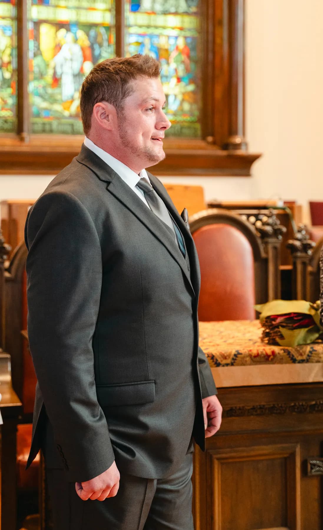 A portrait of the groom inside the church at Kody and Jaz’s wedding.