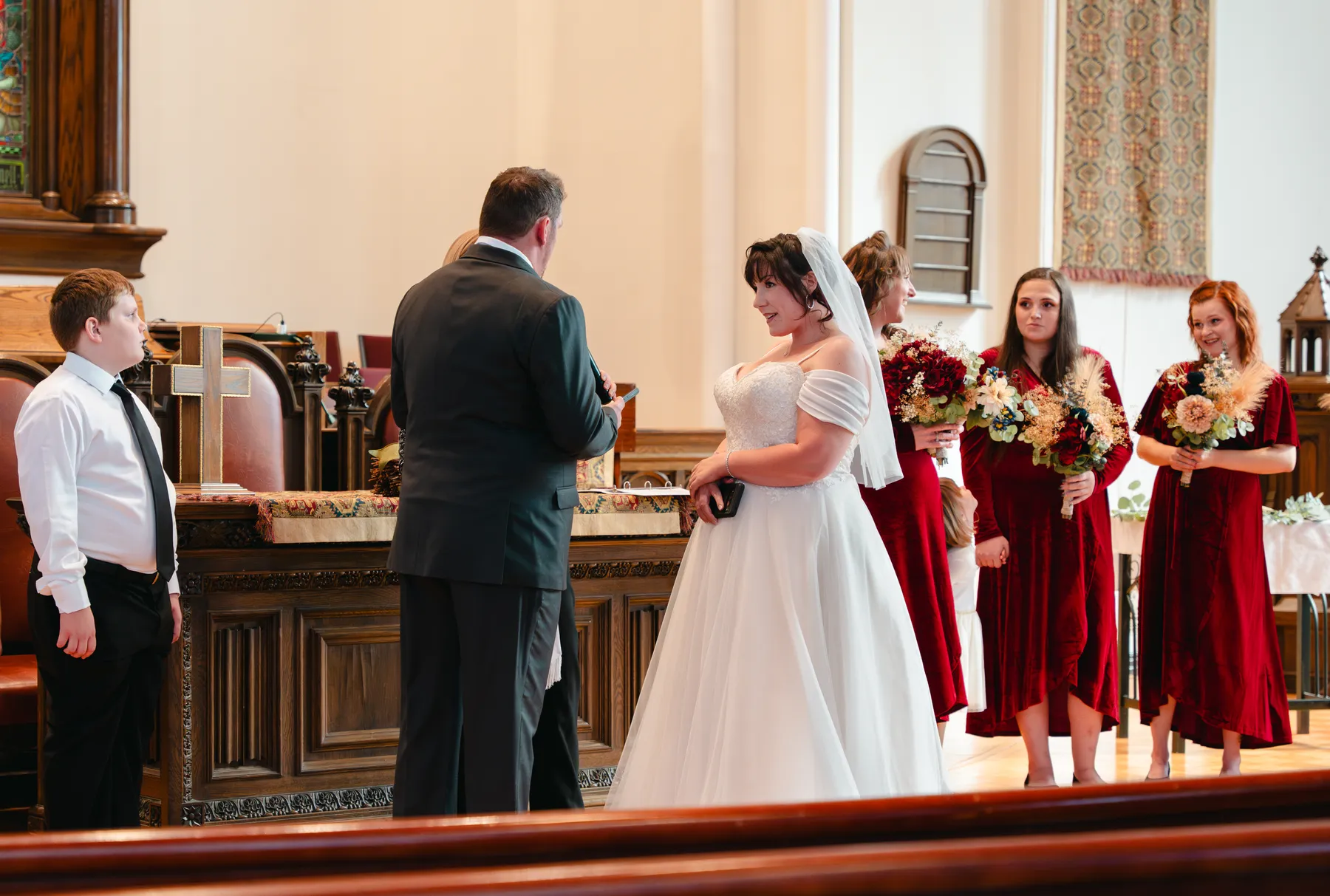 The couple and wedding party during the church ceremony at Kody and Jaz’s wedding.
