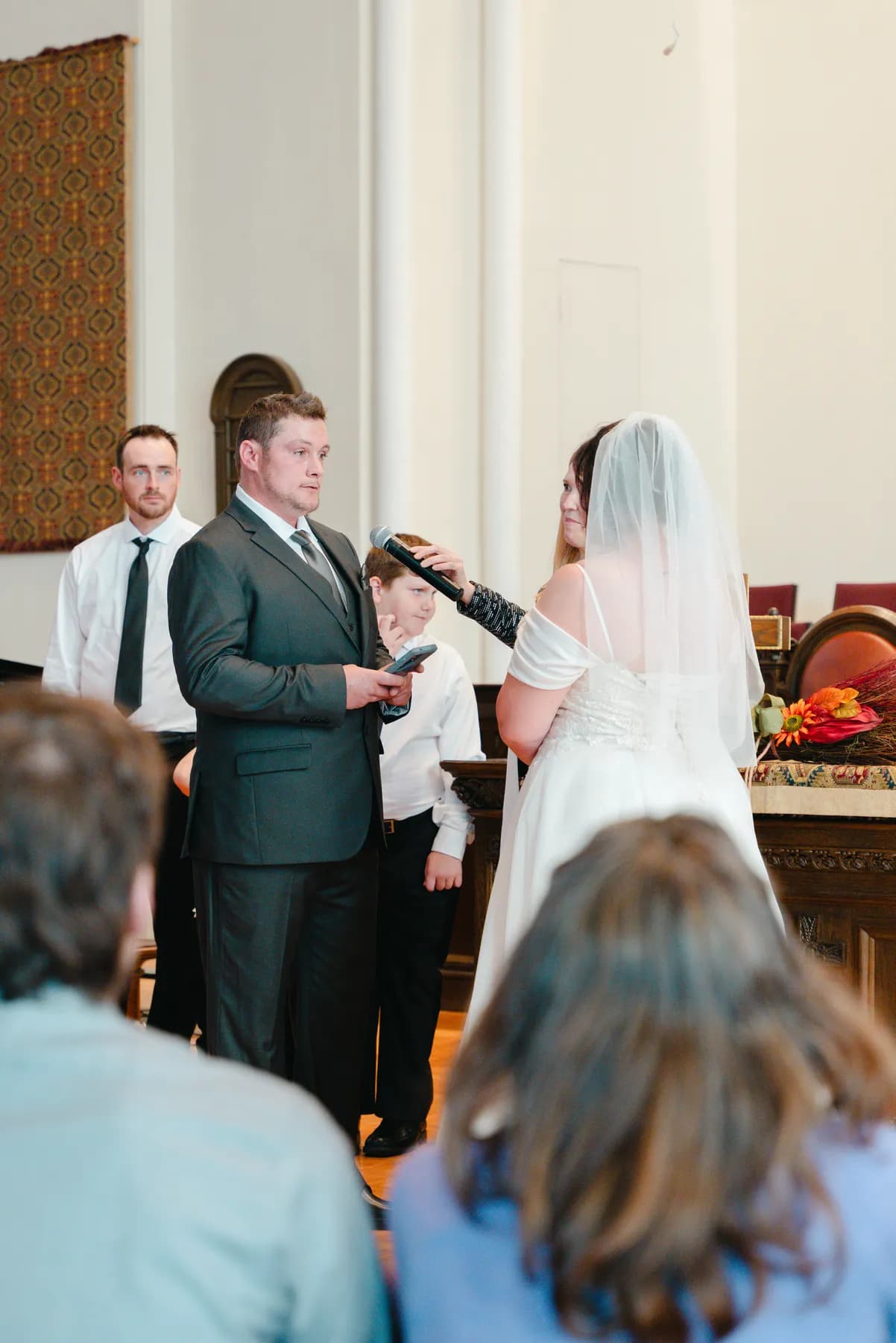 The couple and wedding party during the church ceremony at Kody and Jaz’s wedding.