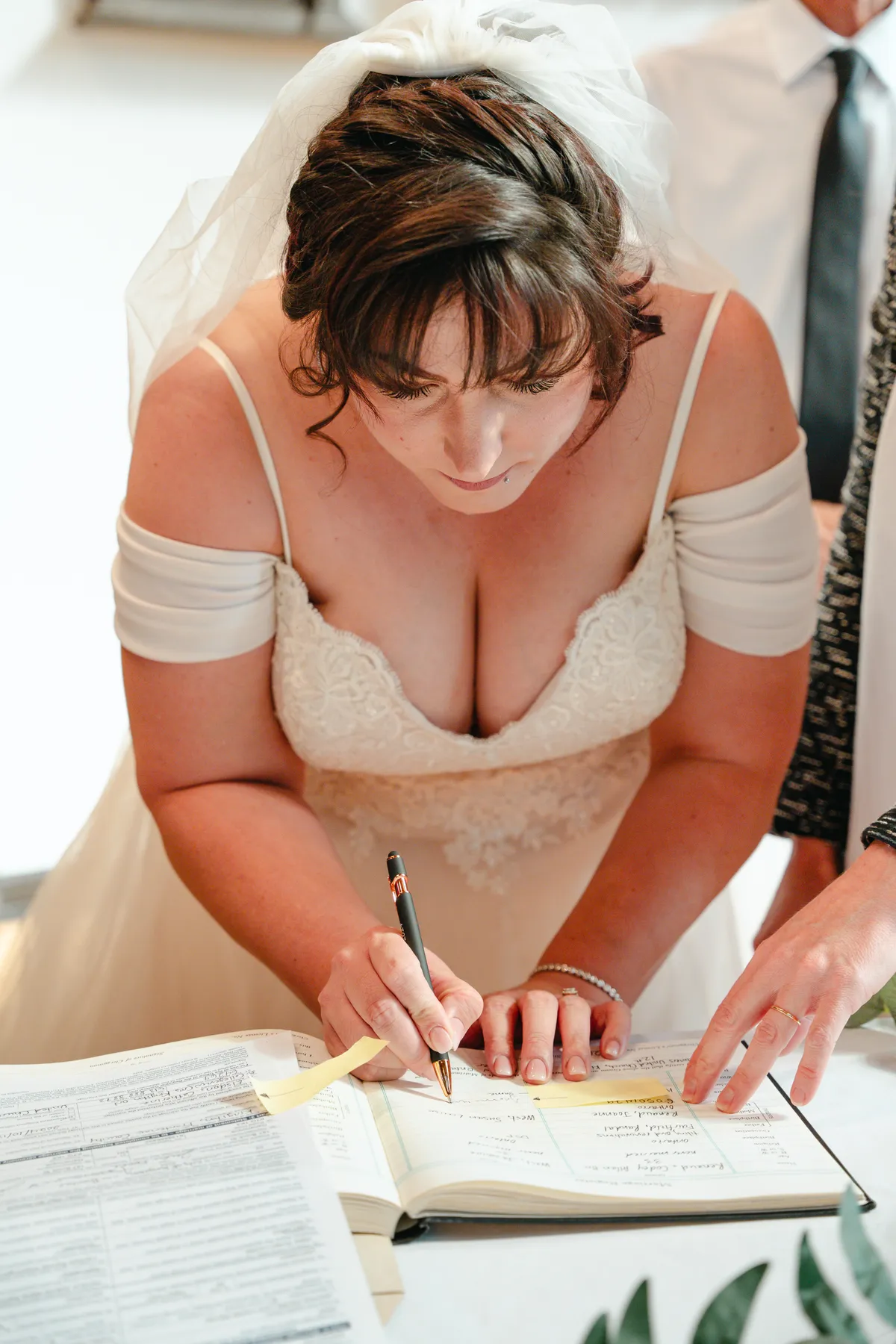 The bride and groom signing wedding documents at Kody and Jaz’s wedding.