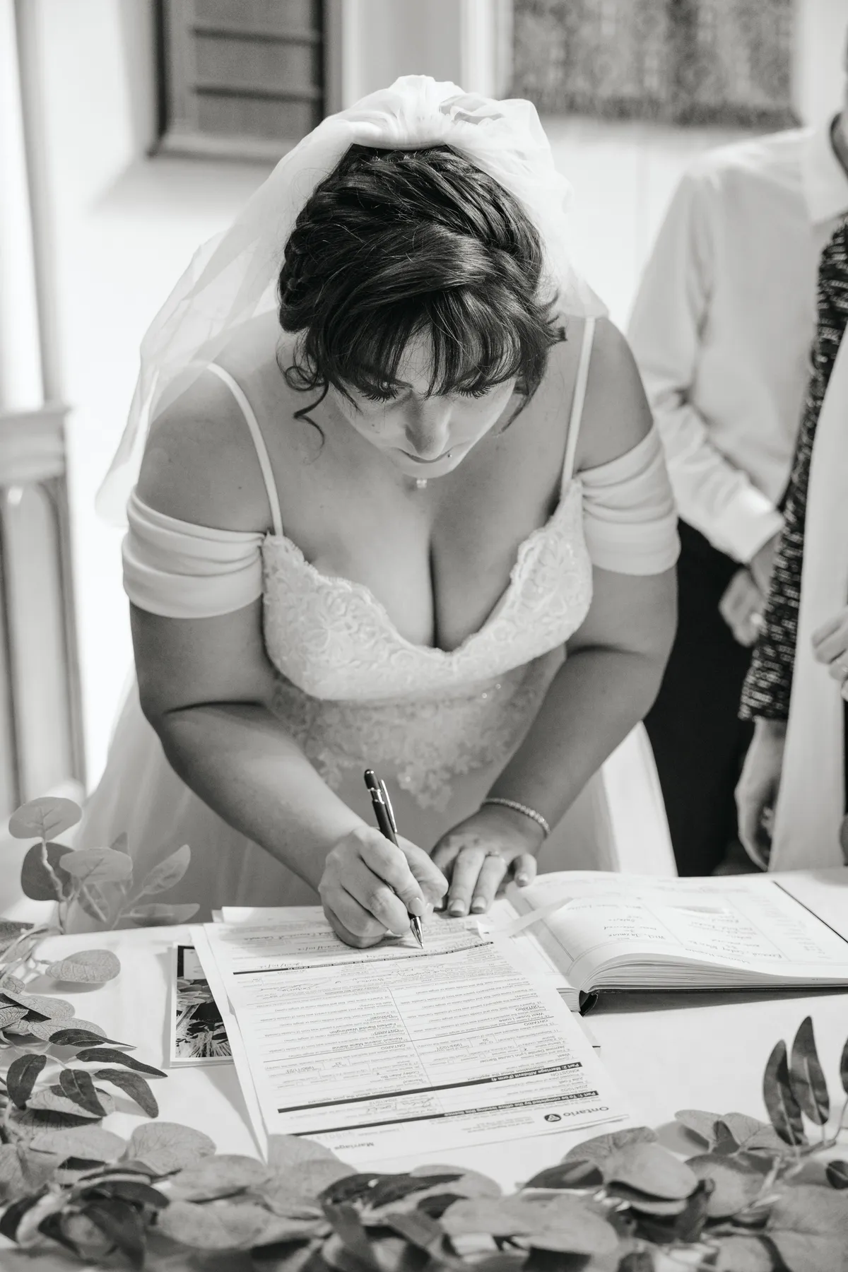 The bride and groom signing wedding documents at Kody and Jaz’s wedding.