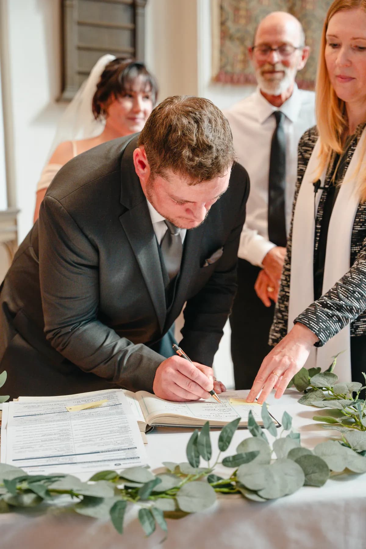 The bride and groom signing wedding documents at Kody and Jaz’s wedding.