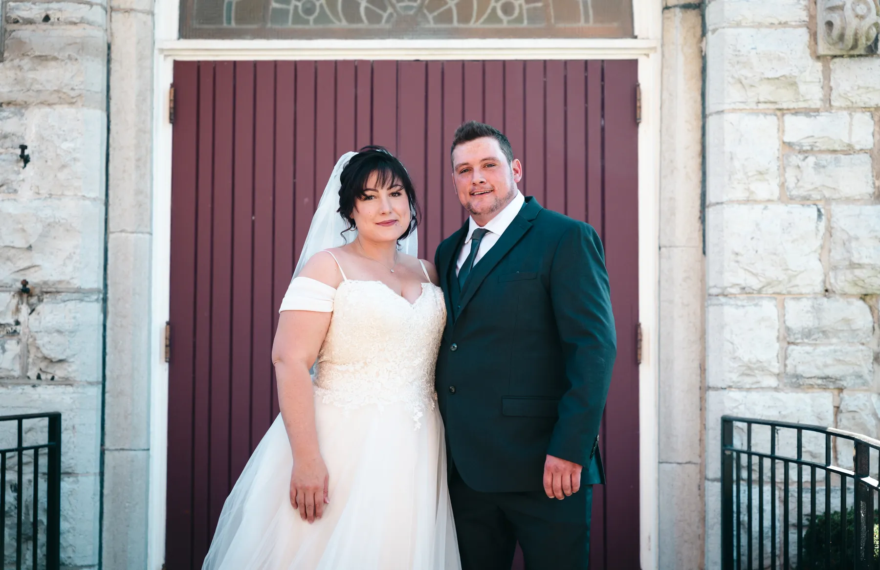 The couple embracing at the church door at Kody and Jaz’s wedding.