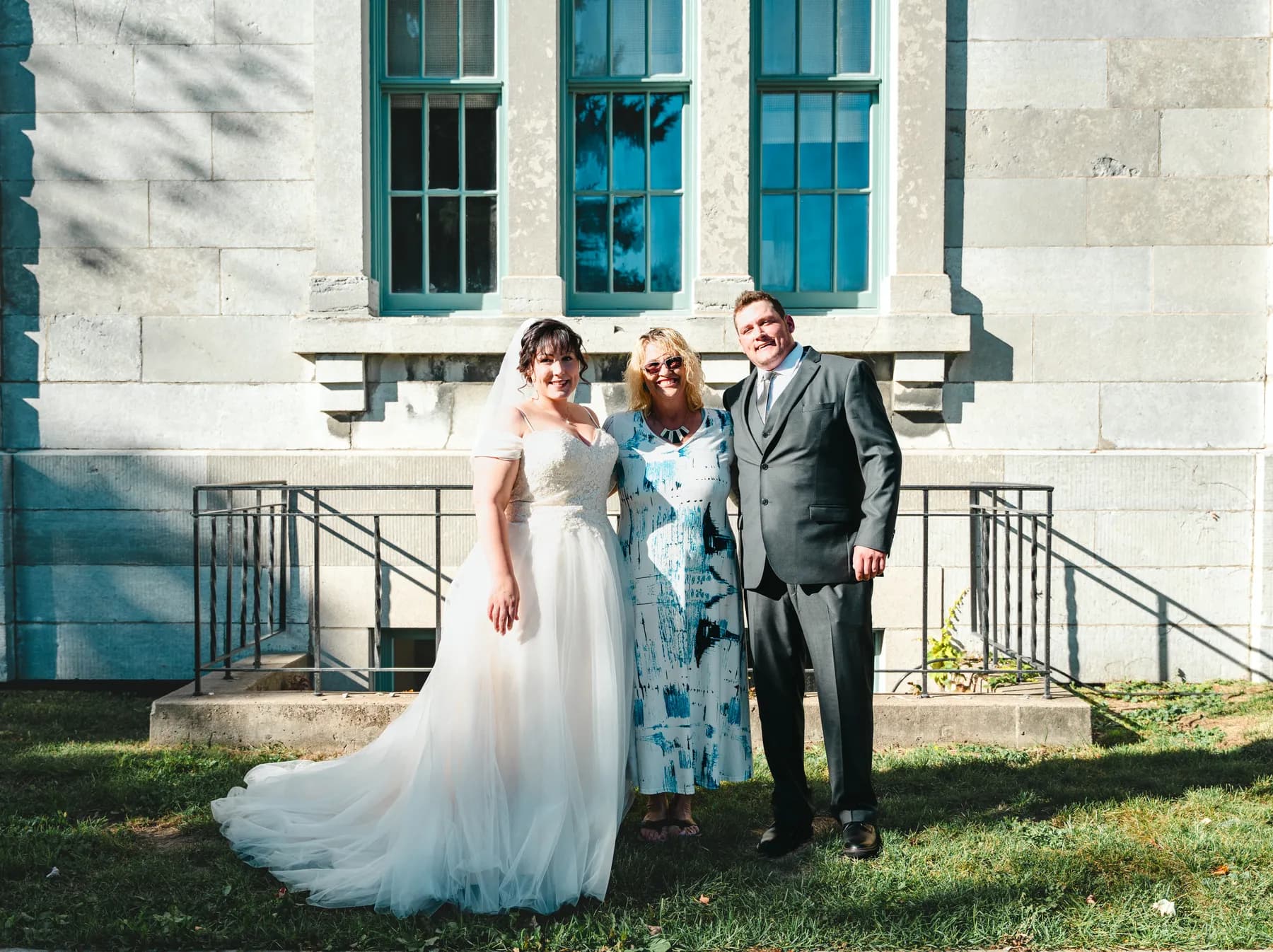 The couple with guests outside a stone building at Kody and Jaz’s wedding.