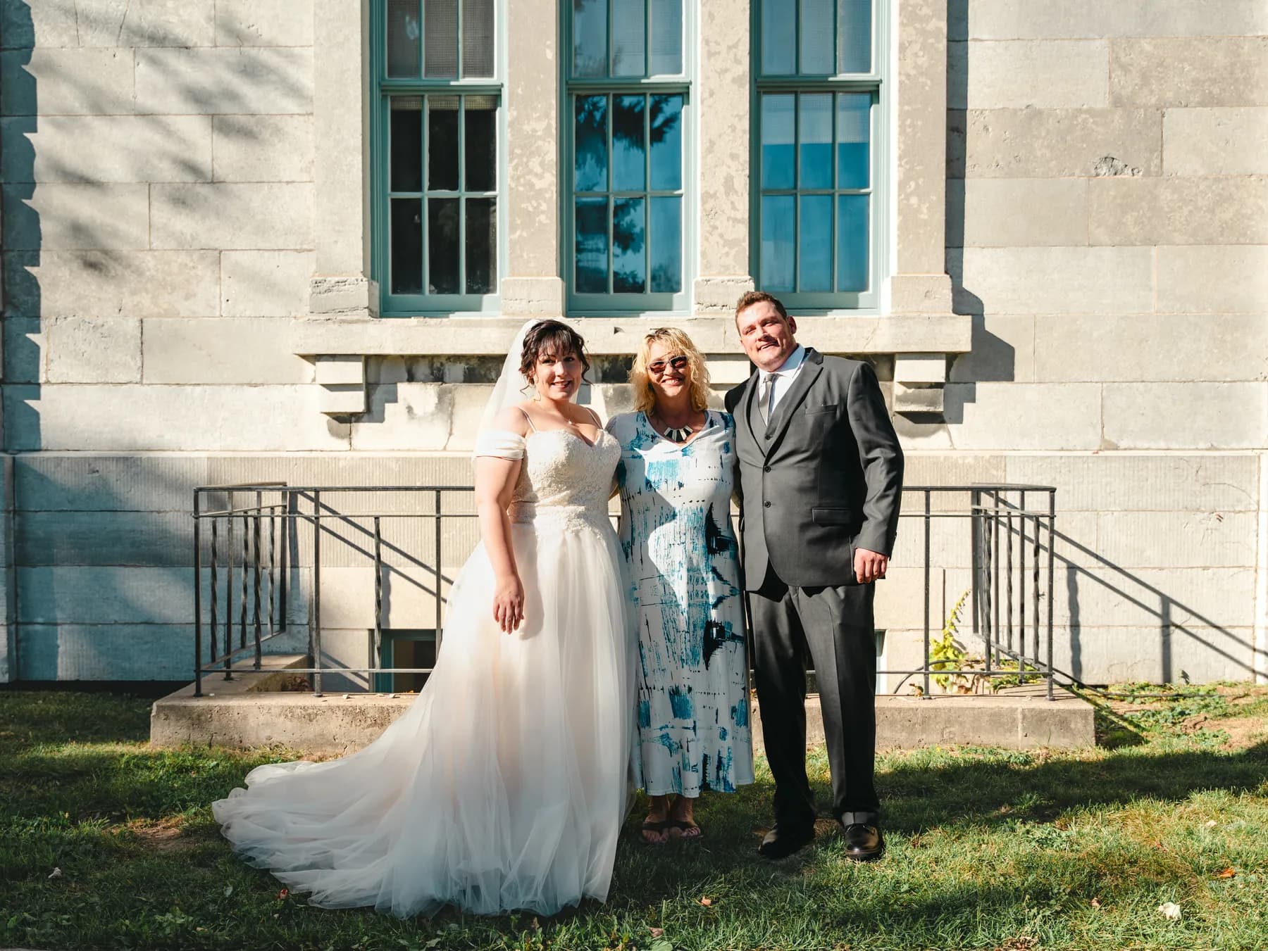 The couple with guests outside a stone building at Kody and Jaz’s wedding.