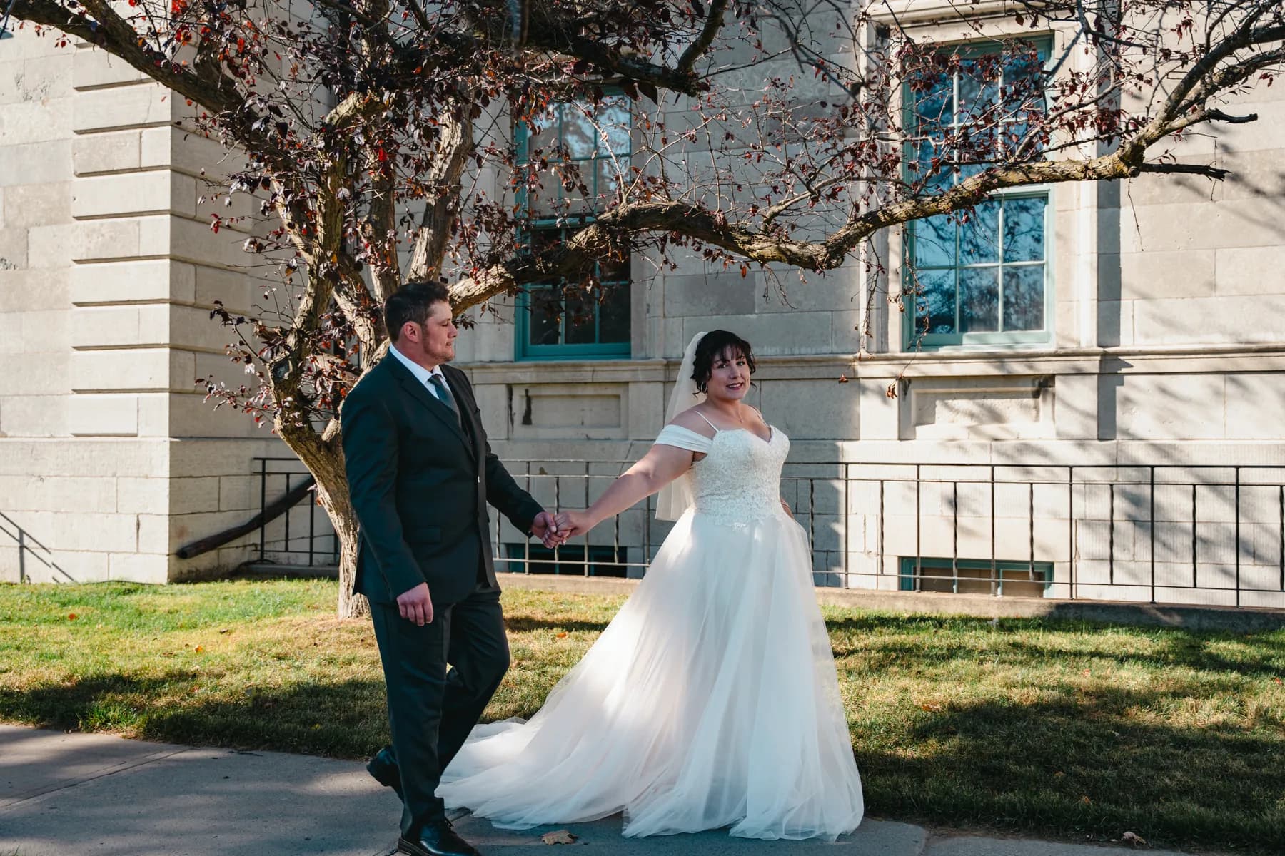 The couple walking outdoors at Kody and Jaz’s wedding.