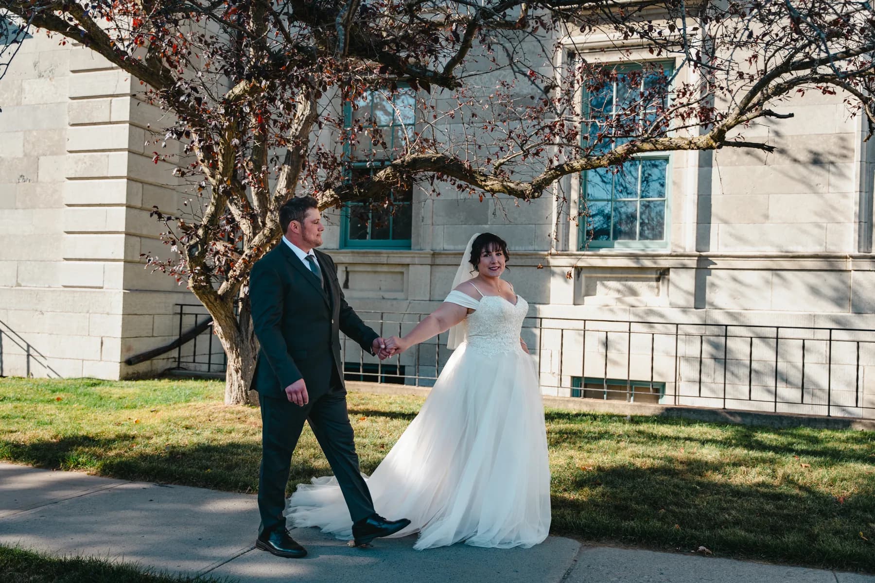 The couple walking outdoors at Kody and Jaz’s wedding.