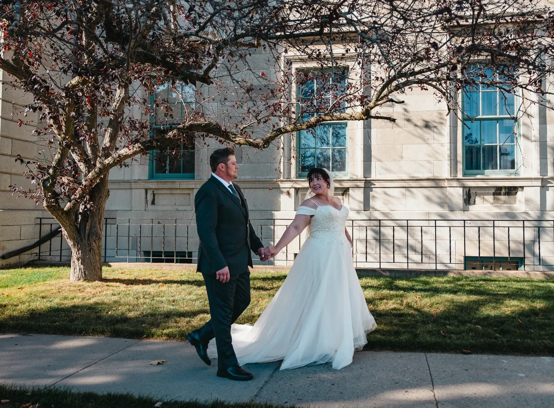 The couple walking outdoors at Kody and Jaz’s wedding.