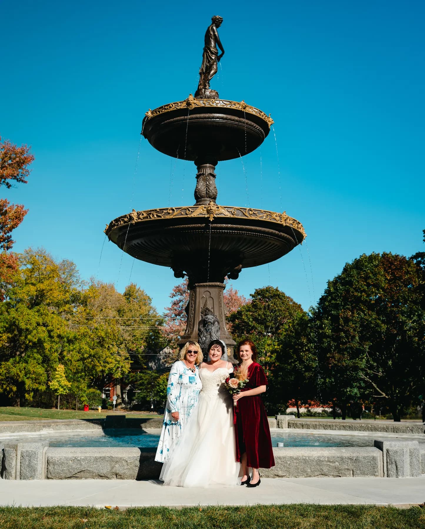 The couple posing by a large fountain at Kody and Jaz’s wedding.