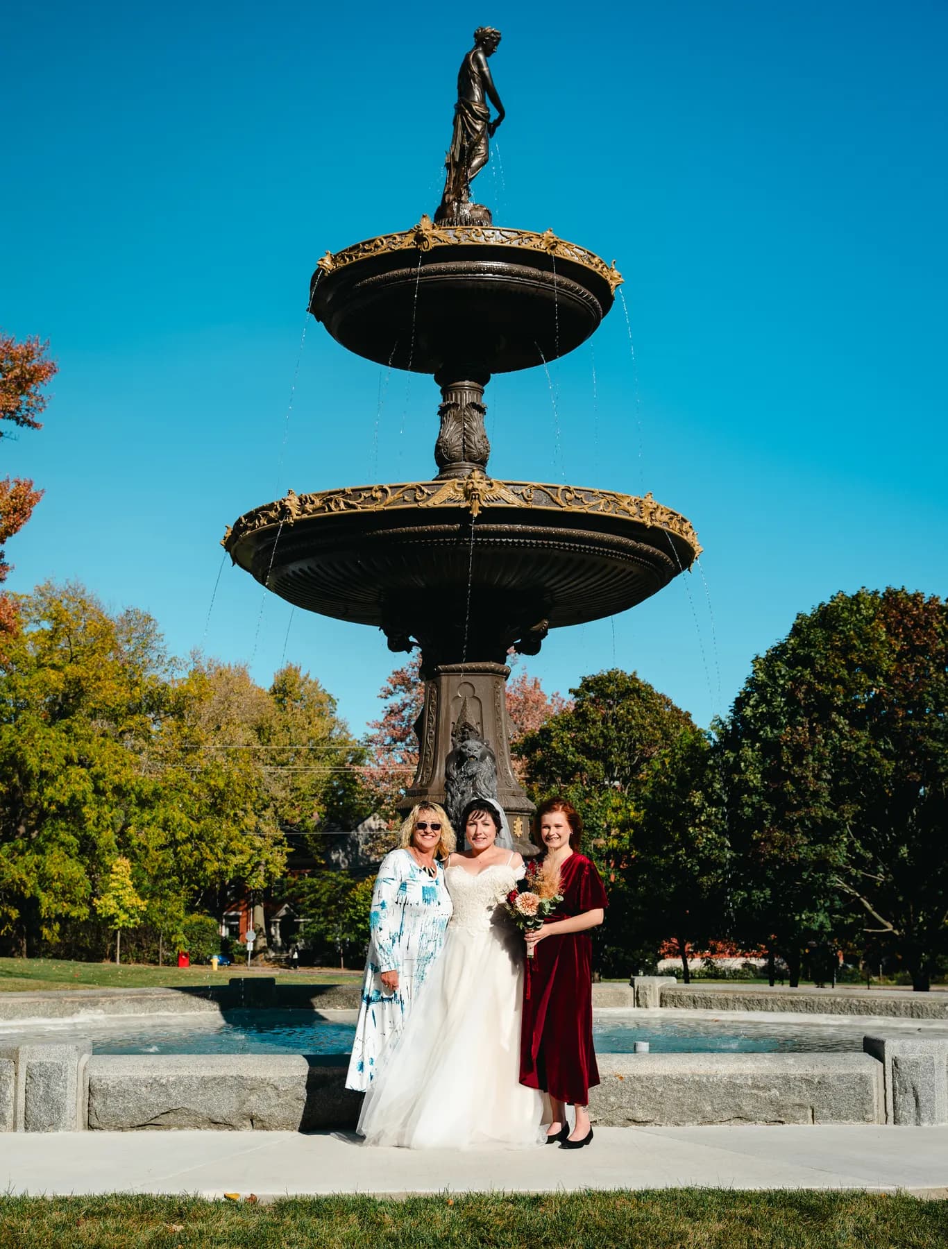 The couple posing by a large fountain at Kody and Jaz’s wedding.