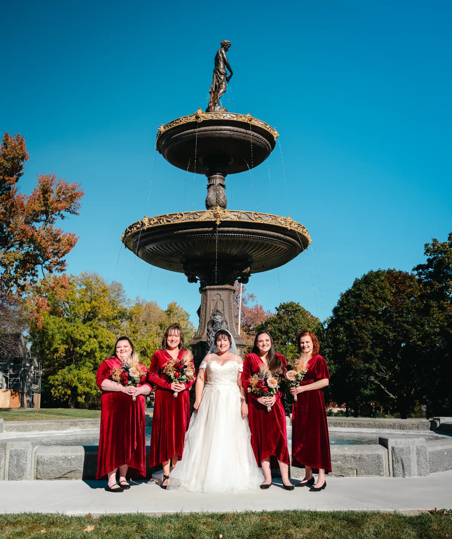 The couple posing by a large fountain at Kody and Jaz’s wedding.