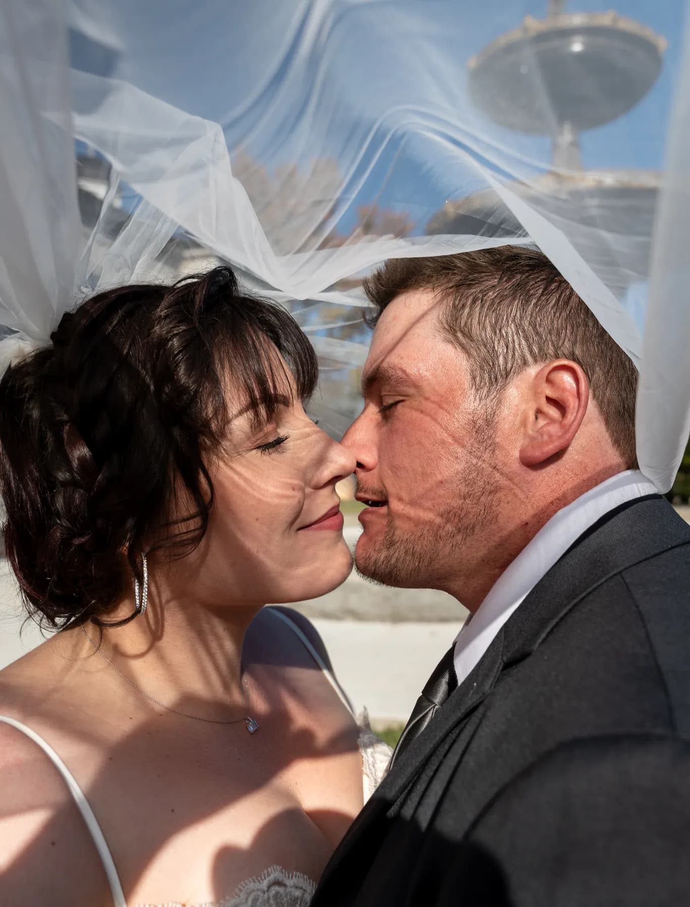 The couple kissing beneath the veil at Kody and Jaz’s wedding.