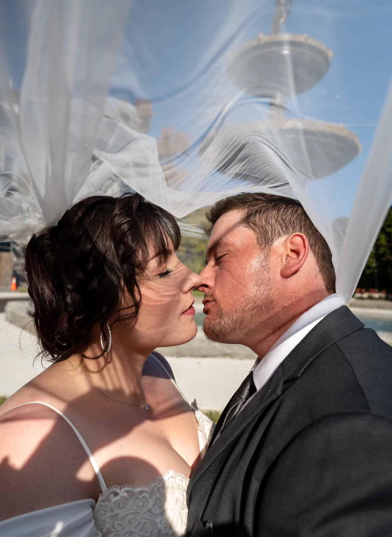 The couple kissing beneath the veil at Kody and Jaz’s wedding.