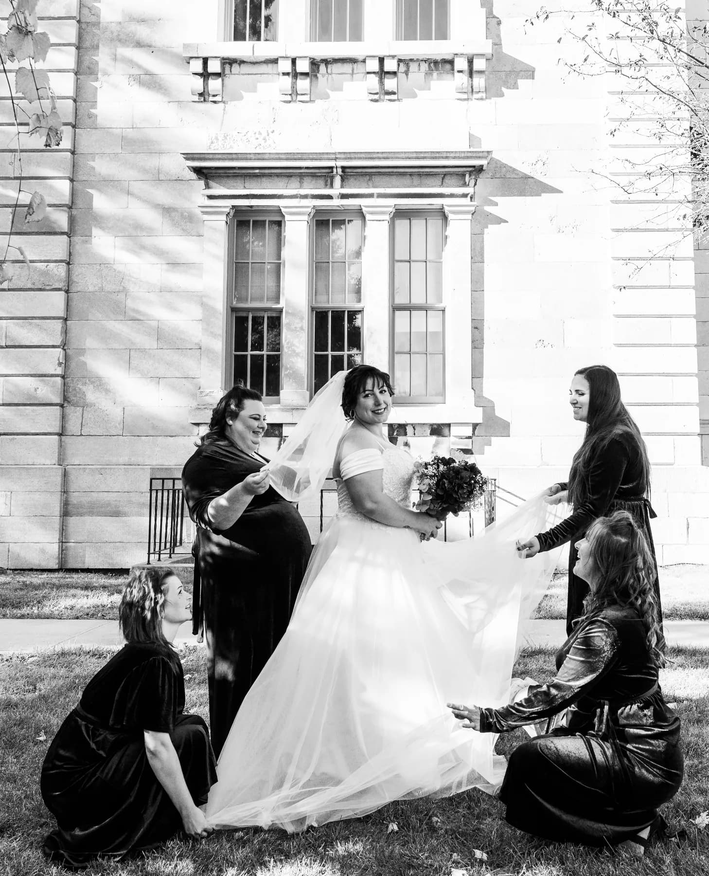 The bride with bridesmaids beside the fountain at Kody and Jaz’s wedding.