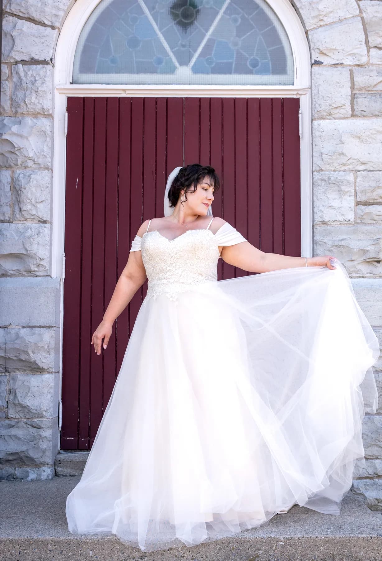 The bride posing outside the church at Kody and Jaz’s wedding.