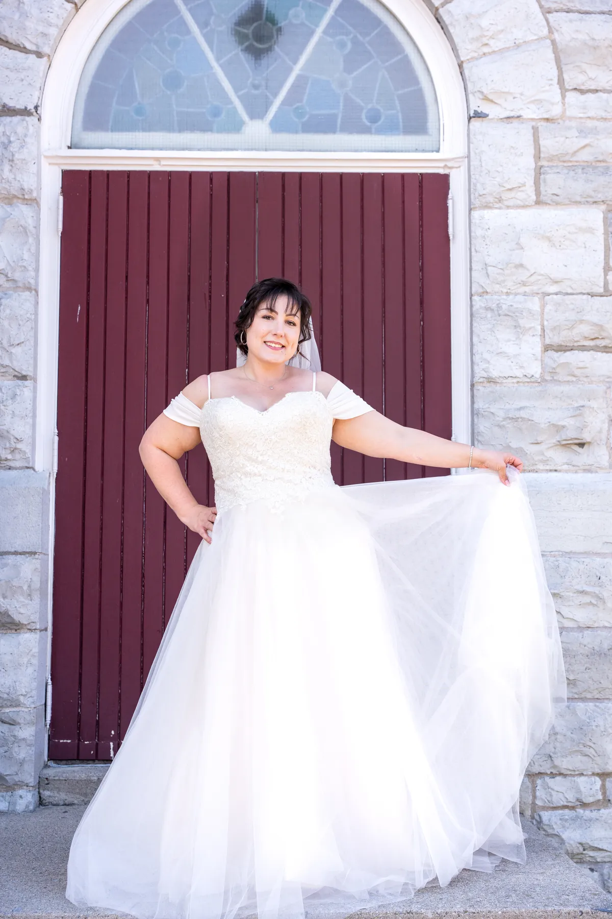 The bride posing outside the church at Kody and Jaz’s wedding.