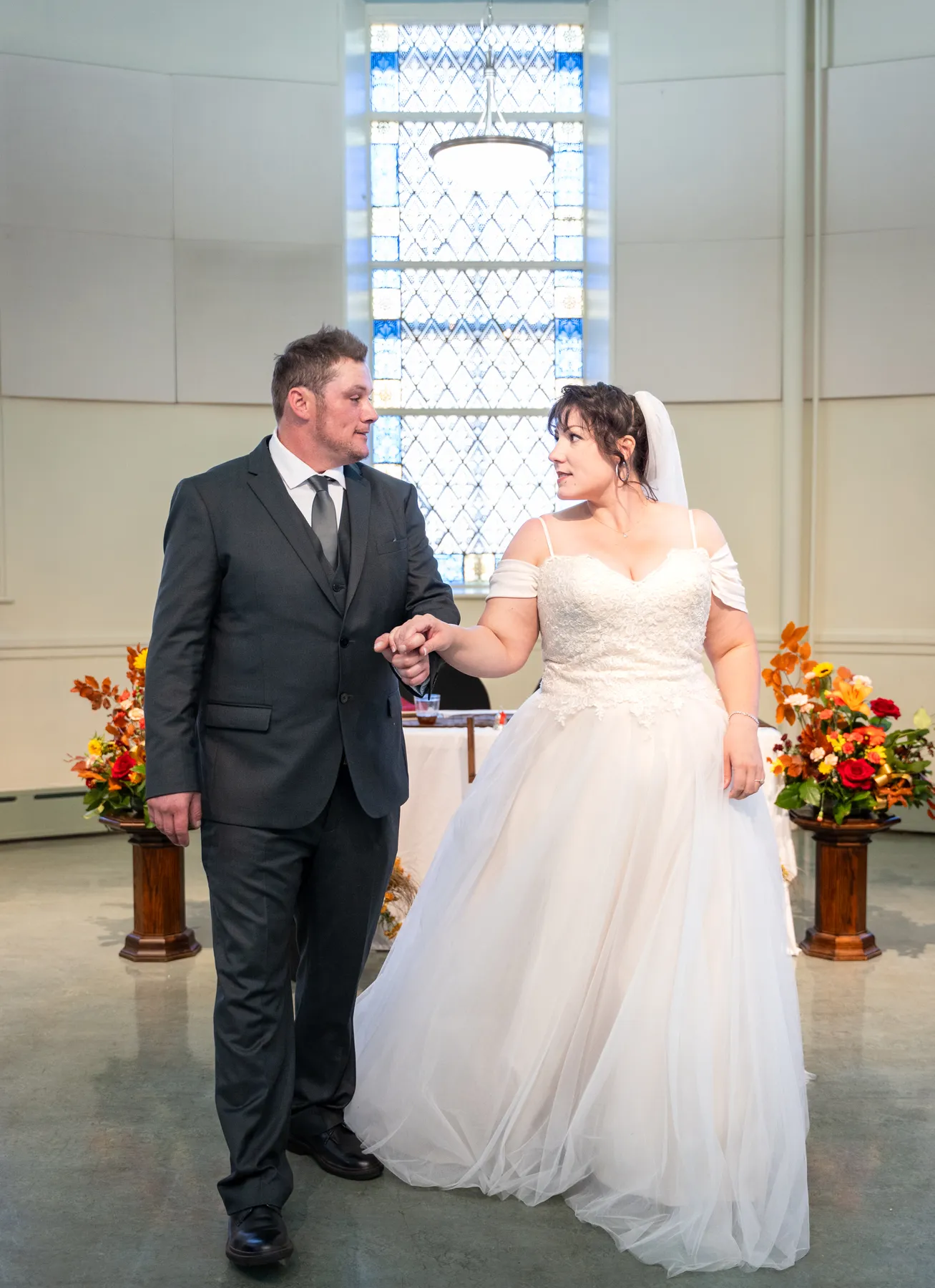 The couple embracing indoors at Kody and Jaz’s wedding.