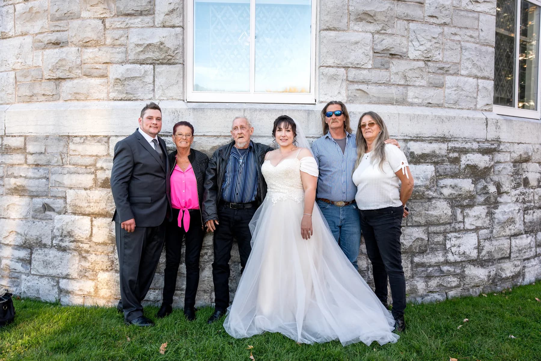 The bride with guests outside the church at Kody and Jaz’s wedding.