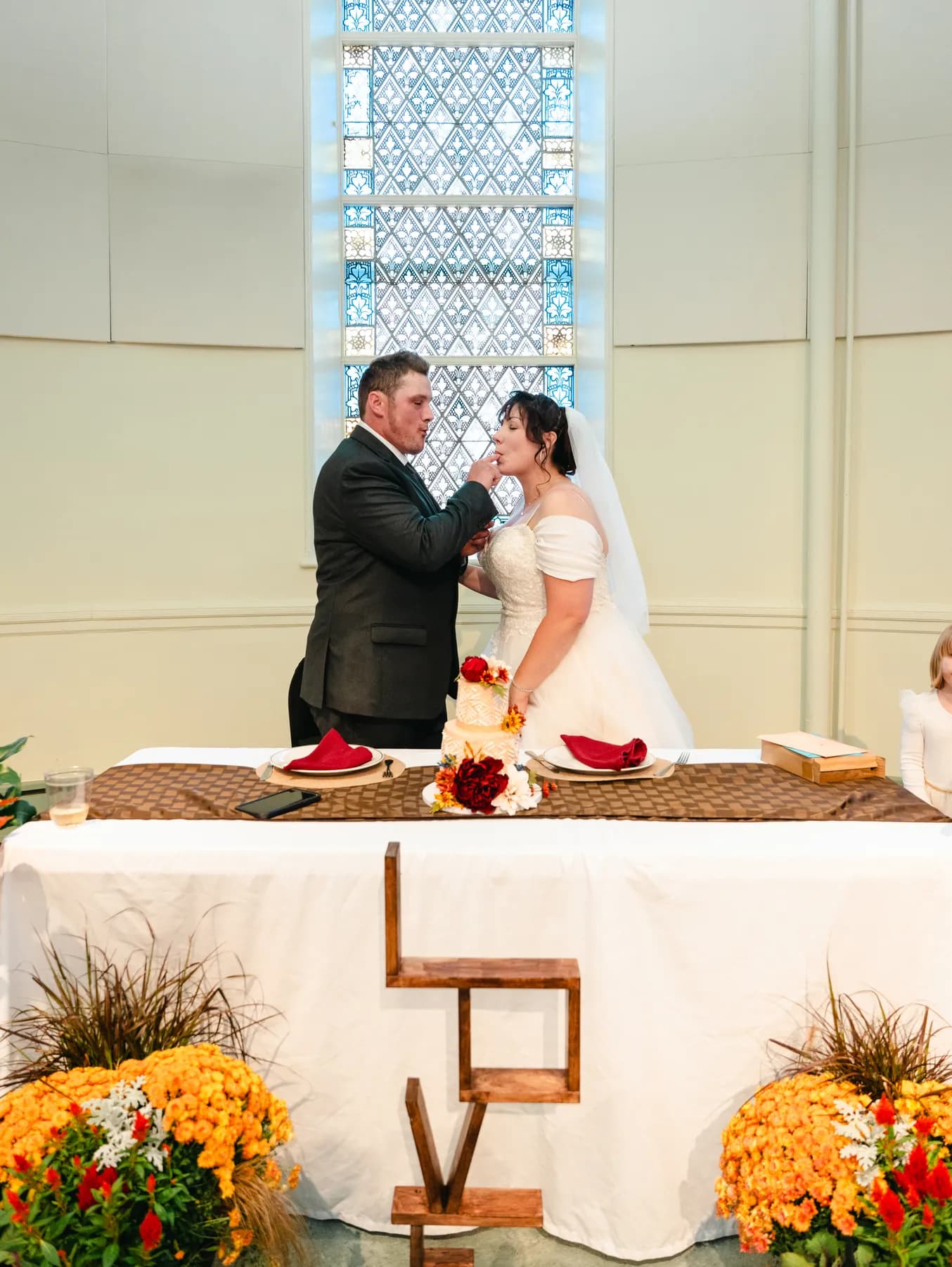 The couple feeding each other wedding cake at Kody and Jaz’s wedding.