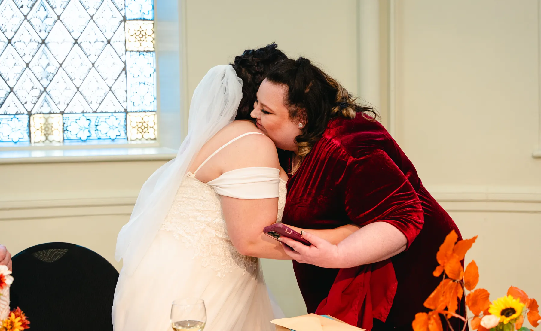 The bride greeting and hugging guests at Kody and Jaz’s wedding.