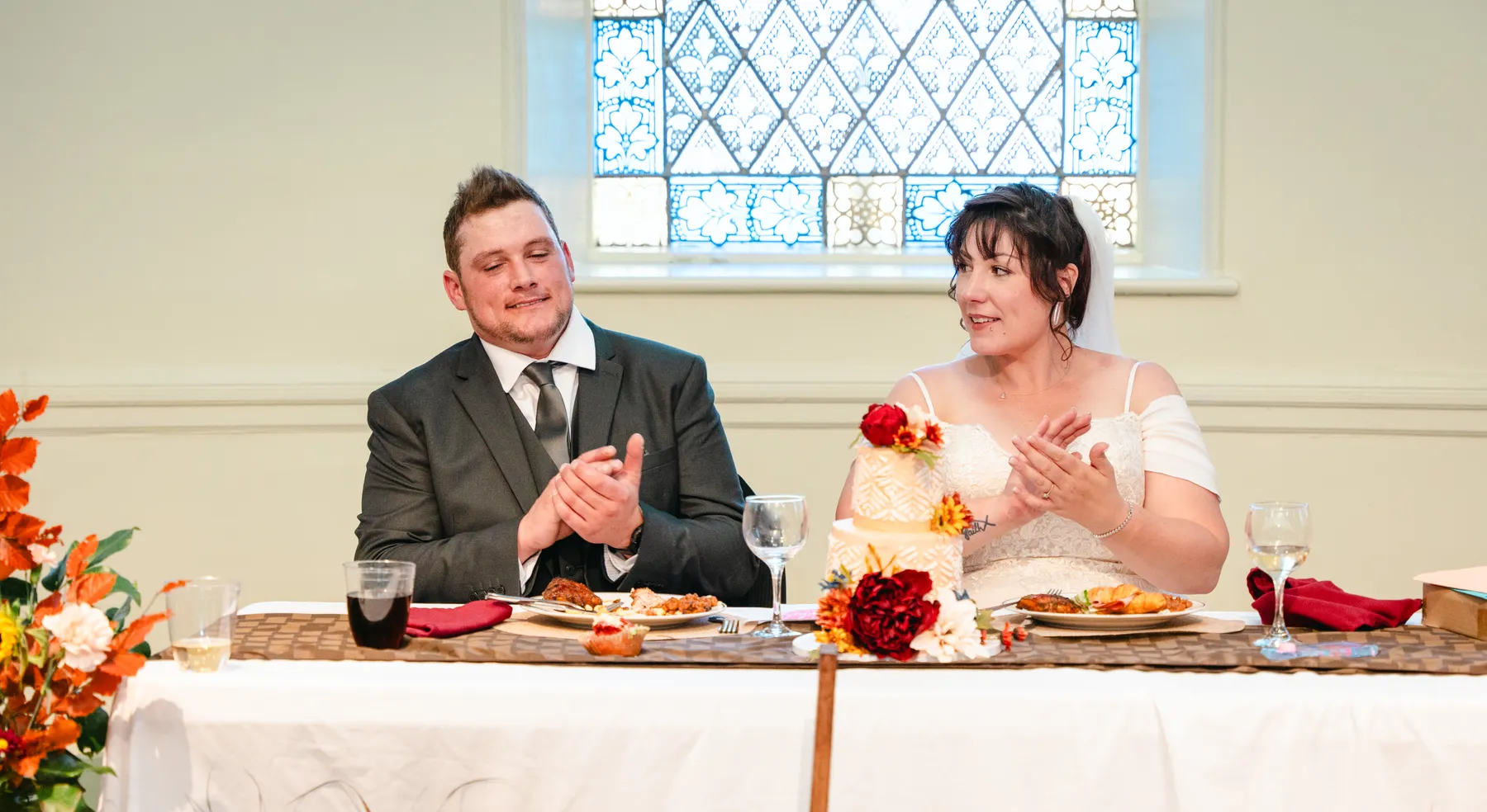 The couple at the head table during speeches at Kody and Jaz’s wedding.