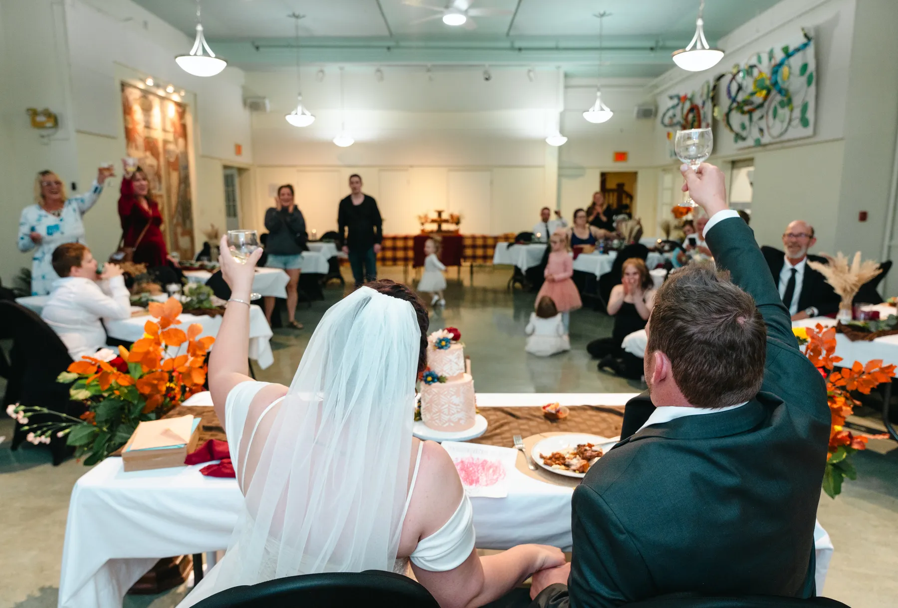 The couple at the head table during speeches at Kody and Jaz’s wedding.