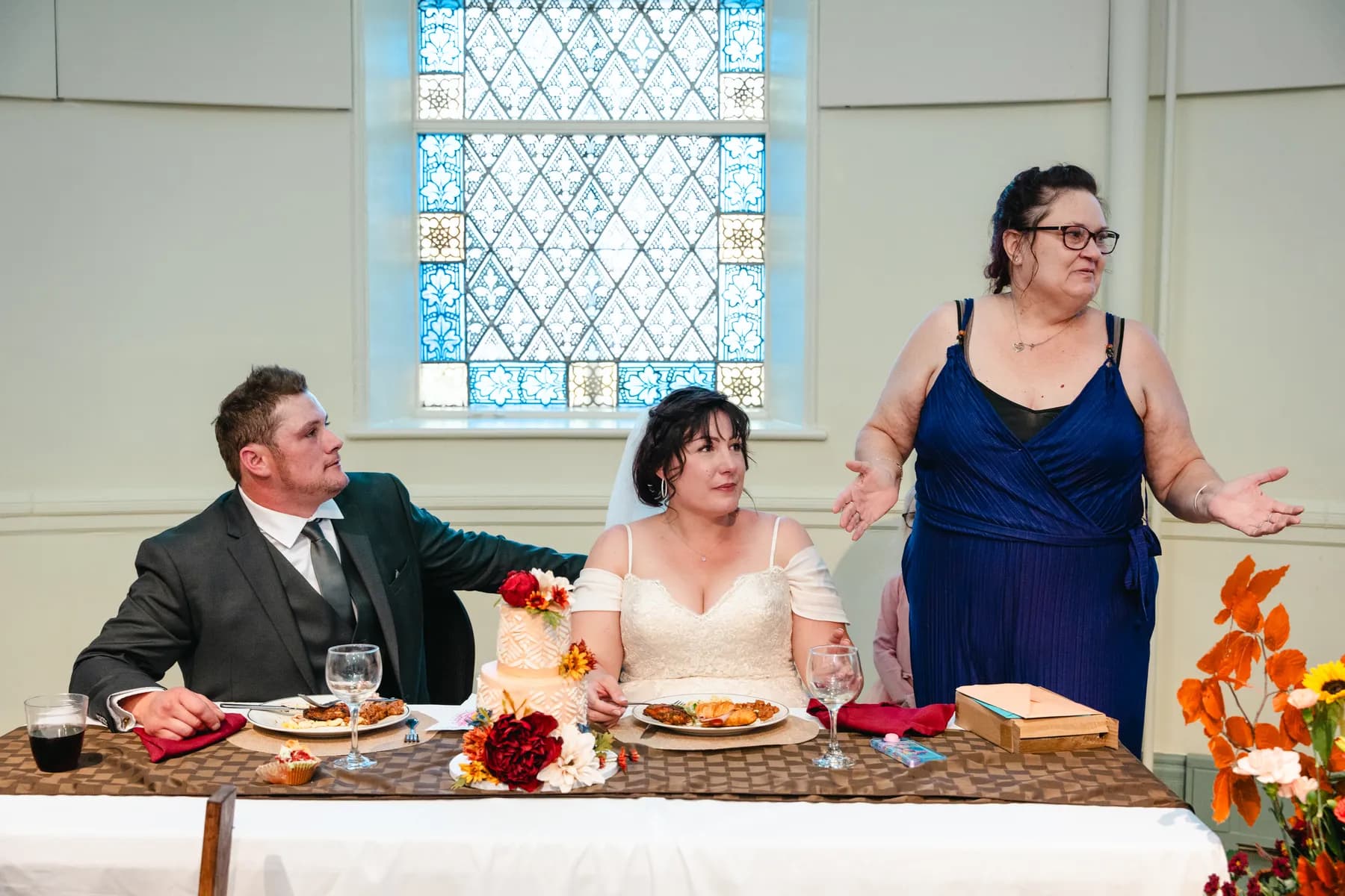 The couple at the head table during speeches at Kody and Jaz’s wedding.