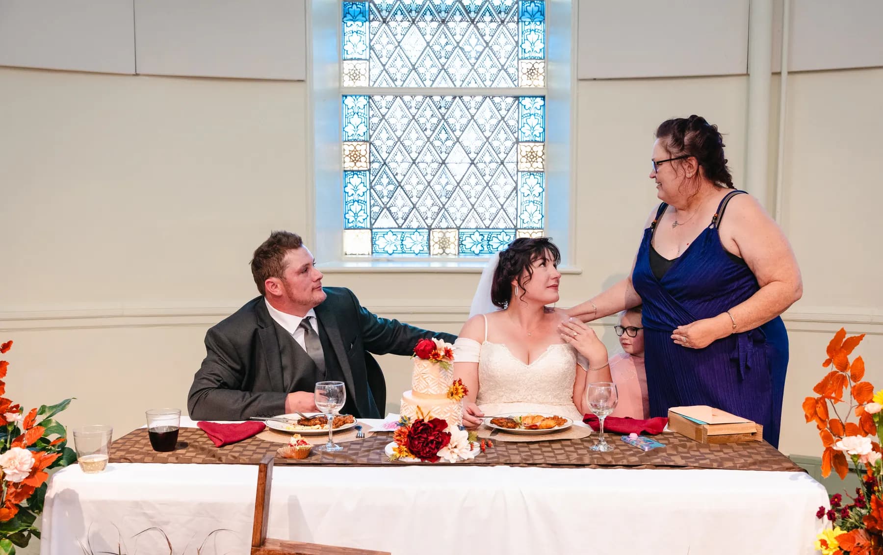 The couple at the head table during speeches at Kody and Jaz’s wedding.