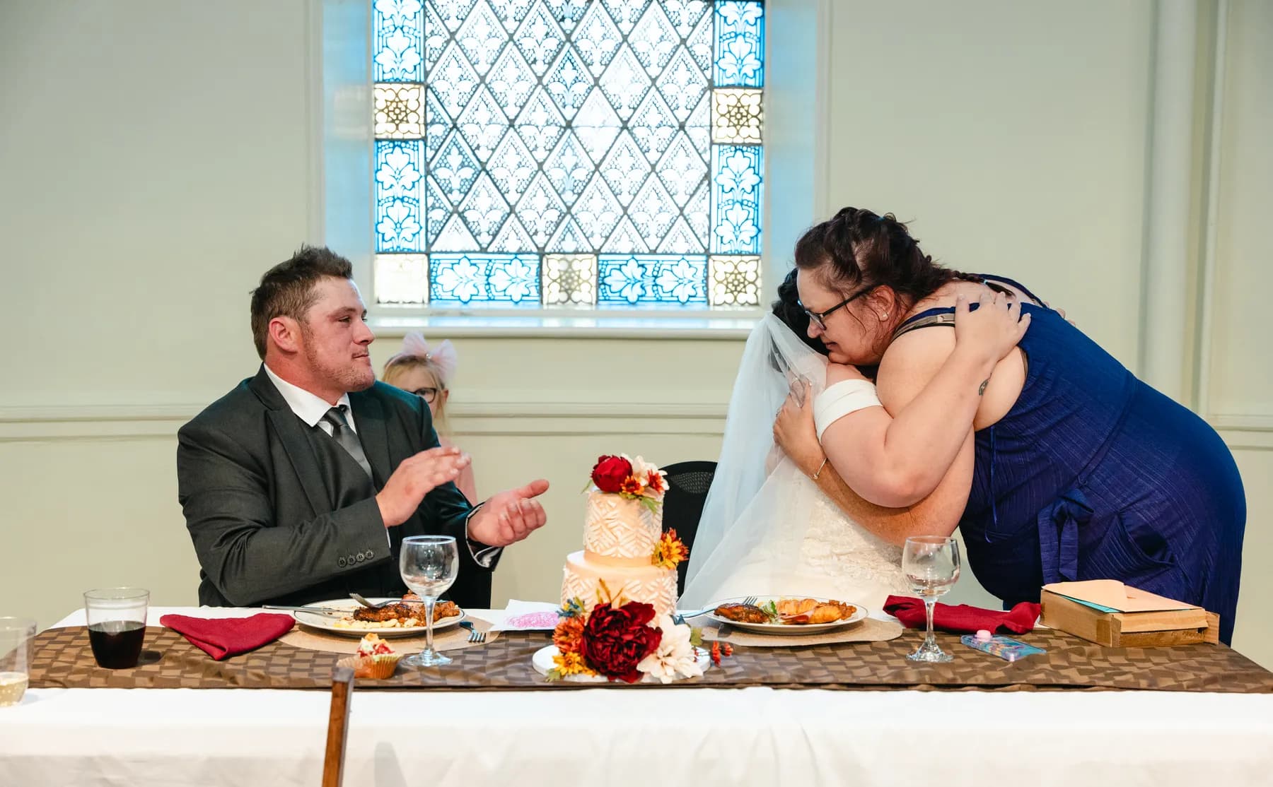 The couple at the head table during speeches at Kody and Jaz’s wedding.