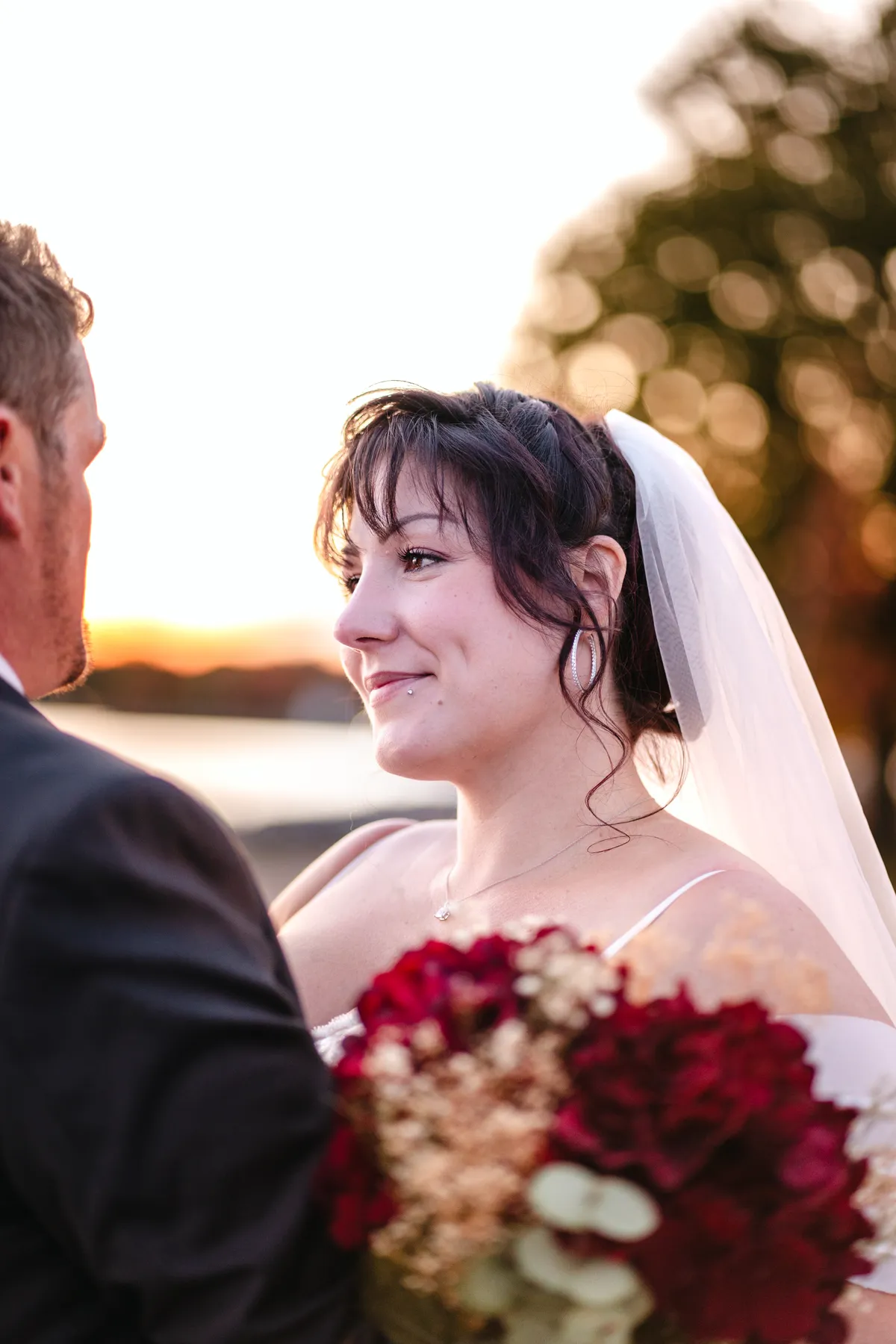 The couple posing by the water at sunset at Kody and Jaz’s wedding.