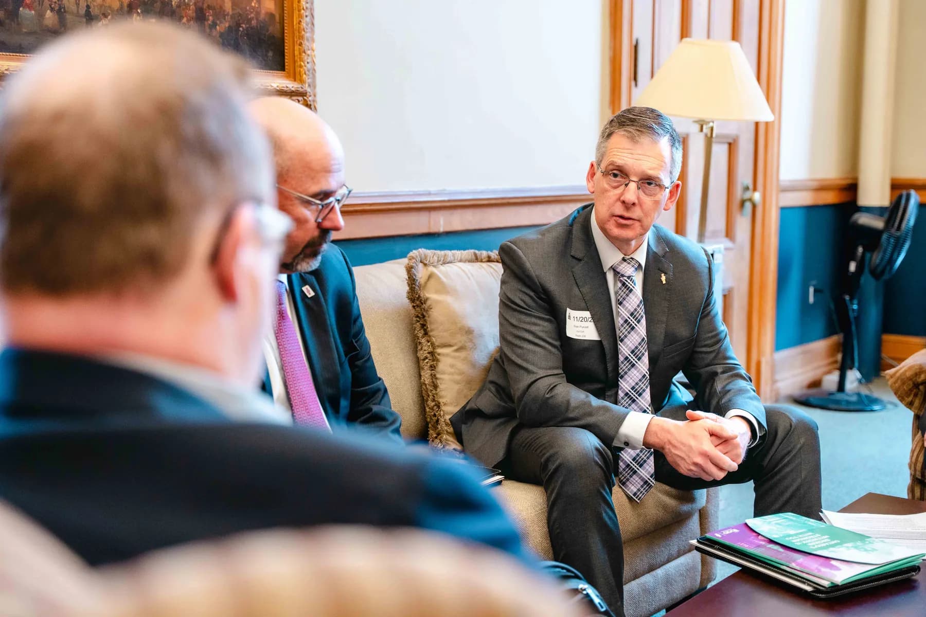 Participants meeting and talking in an office at the IBAO event at Queen’s Park.