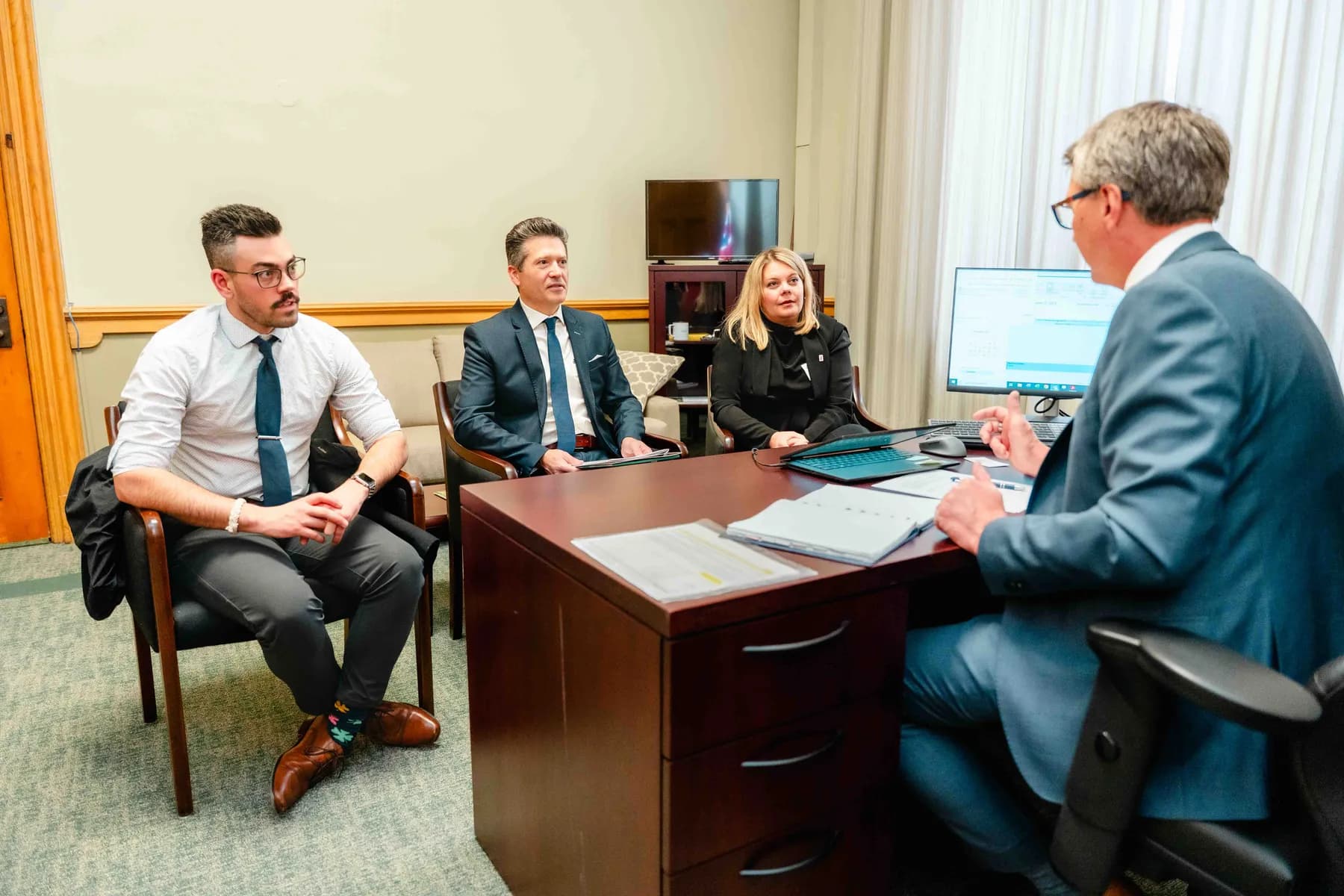 Participants meeting and talking in an office at the IBAO event at Queen’s Park.