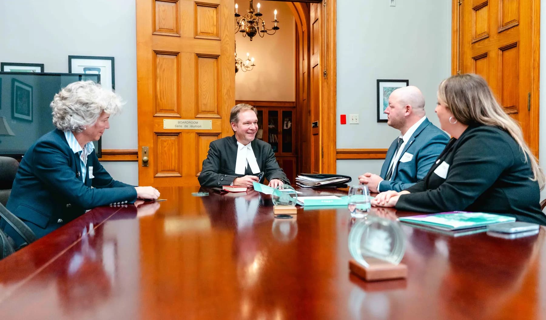 Participants meeting and talking in an office at the IBAO event at Queen’s Park.