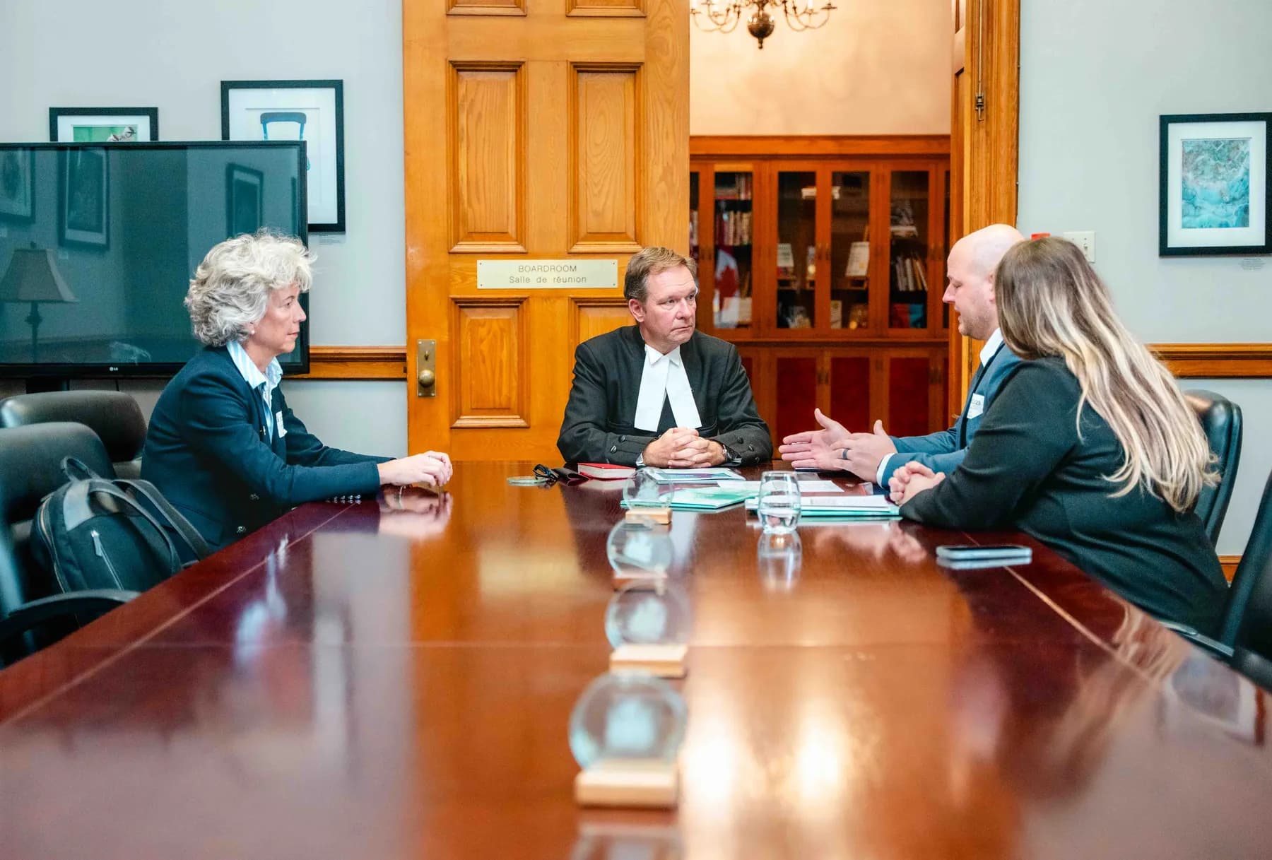 Participants meeting and talking in an office at the IBAO event at Queen’s Park.