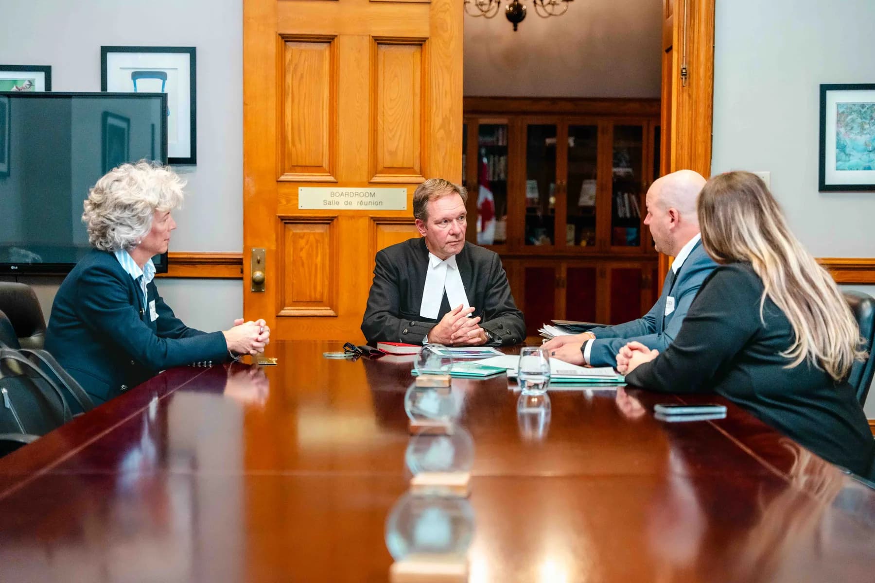 Participants meeting and talking in an office at the IBAO event at Queen’s Park.