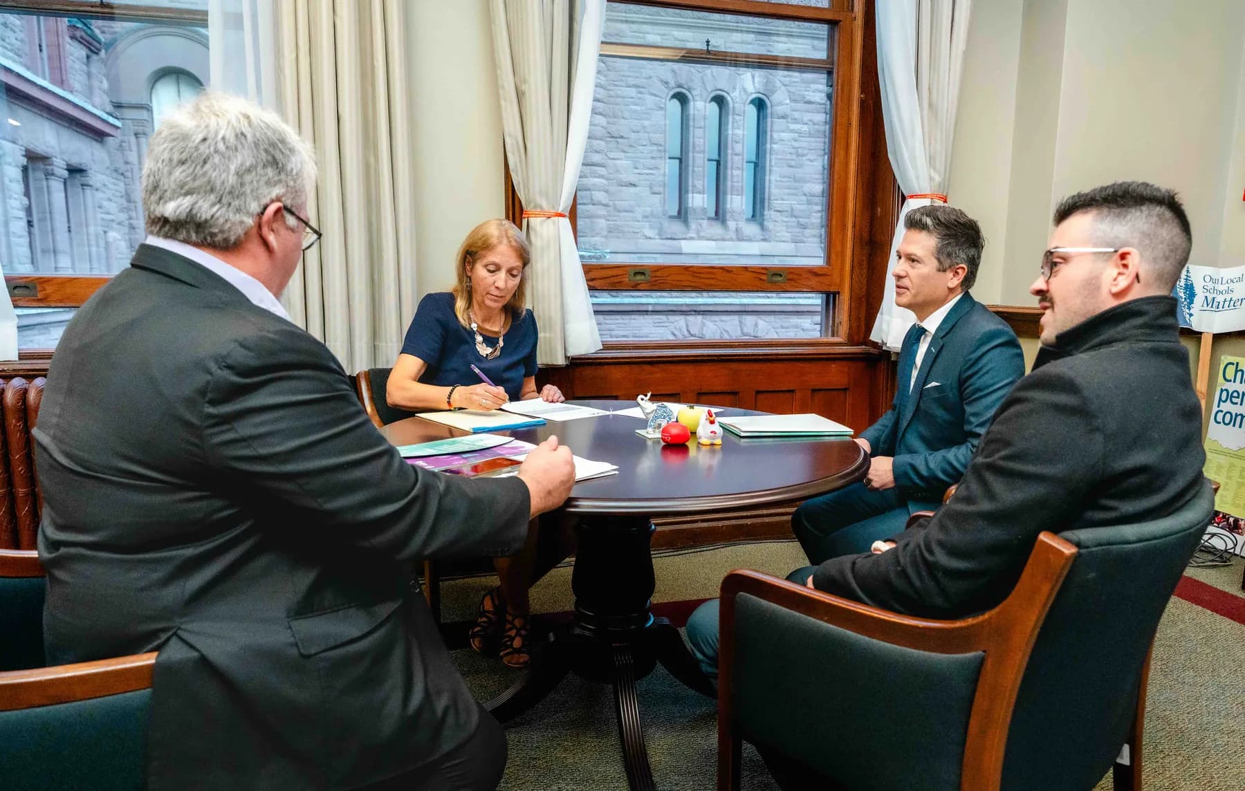Participants meeting and talking in an office at the IBAO event at Queen’s Park.