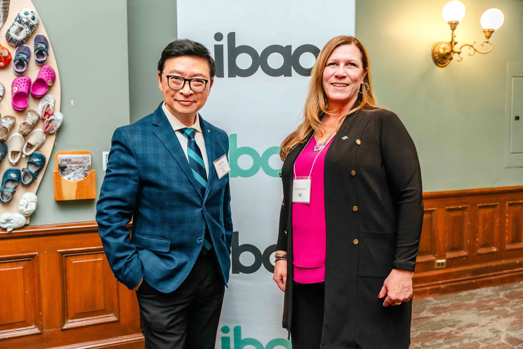 Participants posing beside an IBAO display at the IBAO event at Queen’s Park.
