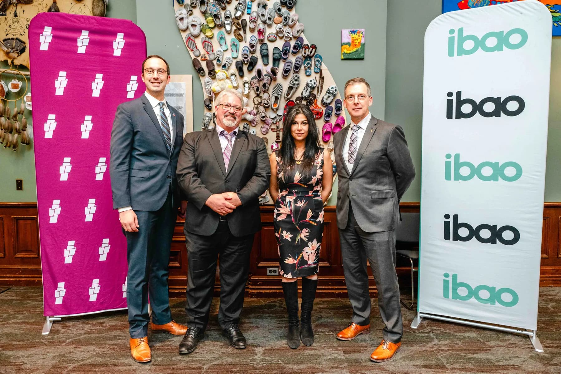 Participants posing beside an IBAO display at the IBAO event at Queen’s Park.