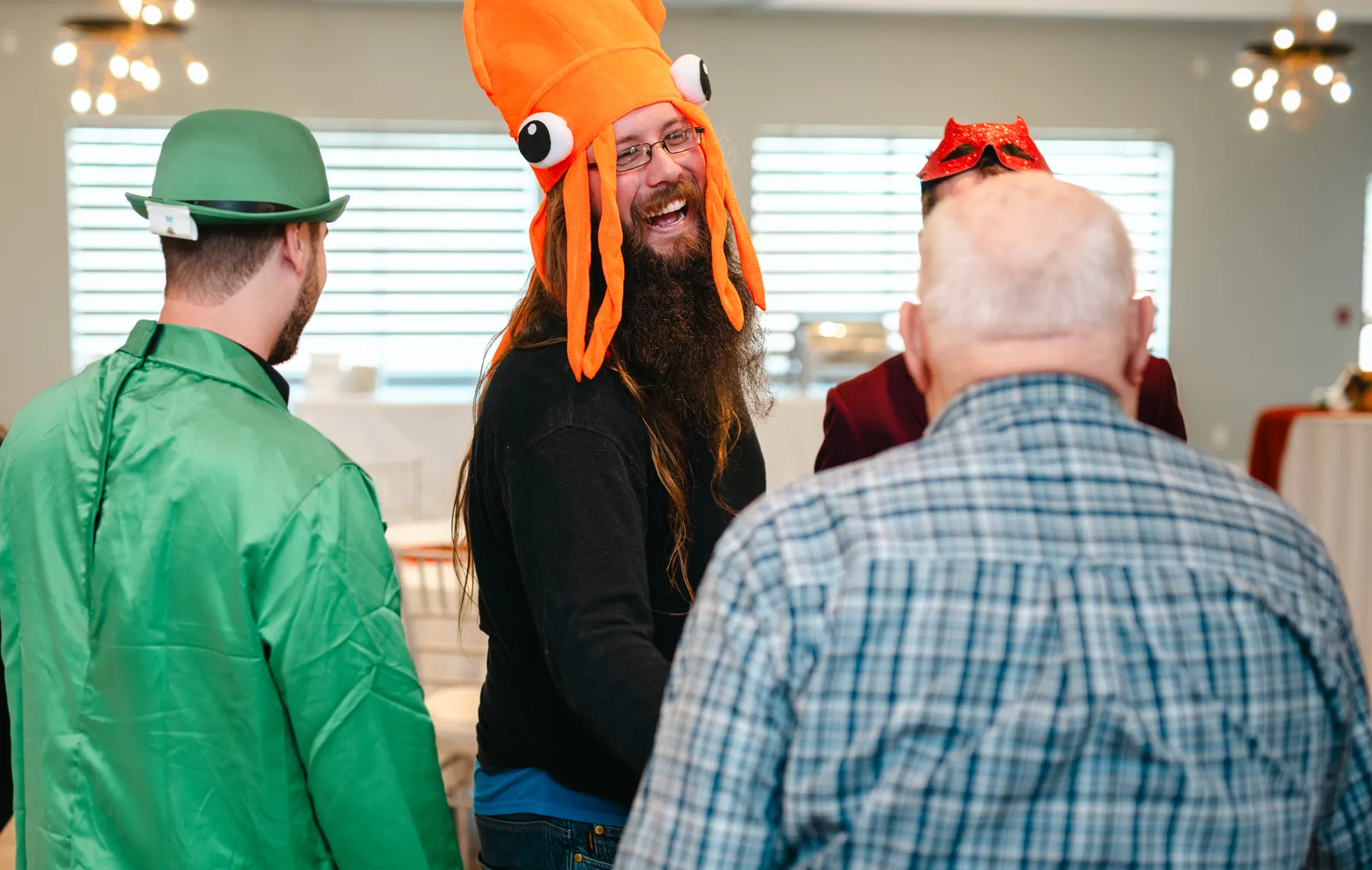 Costumed guests greeting and hugging indoors at Jenna and Jake’s Halloween party.