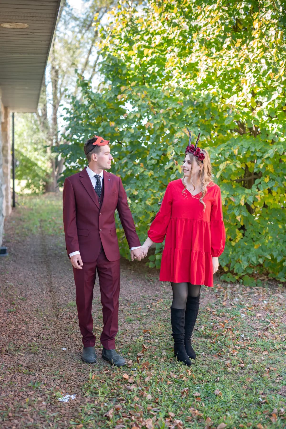A couple posing outdoors near trees at Jenna and Jake’s Halloween party.