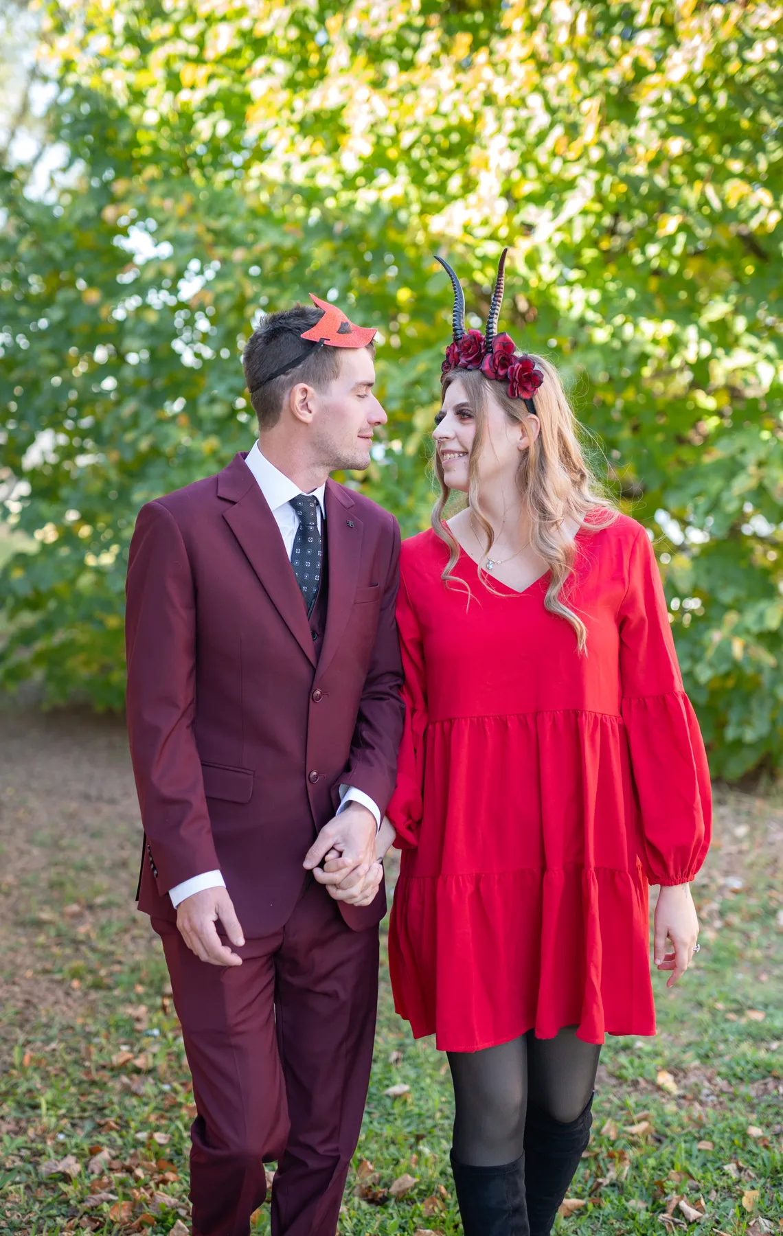 A couple posing outdoors near trees at Jenna and Jake’s Halloween party.