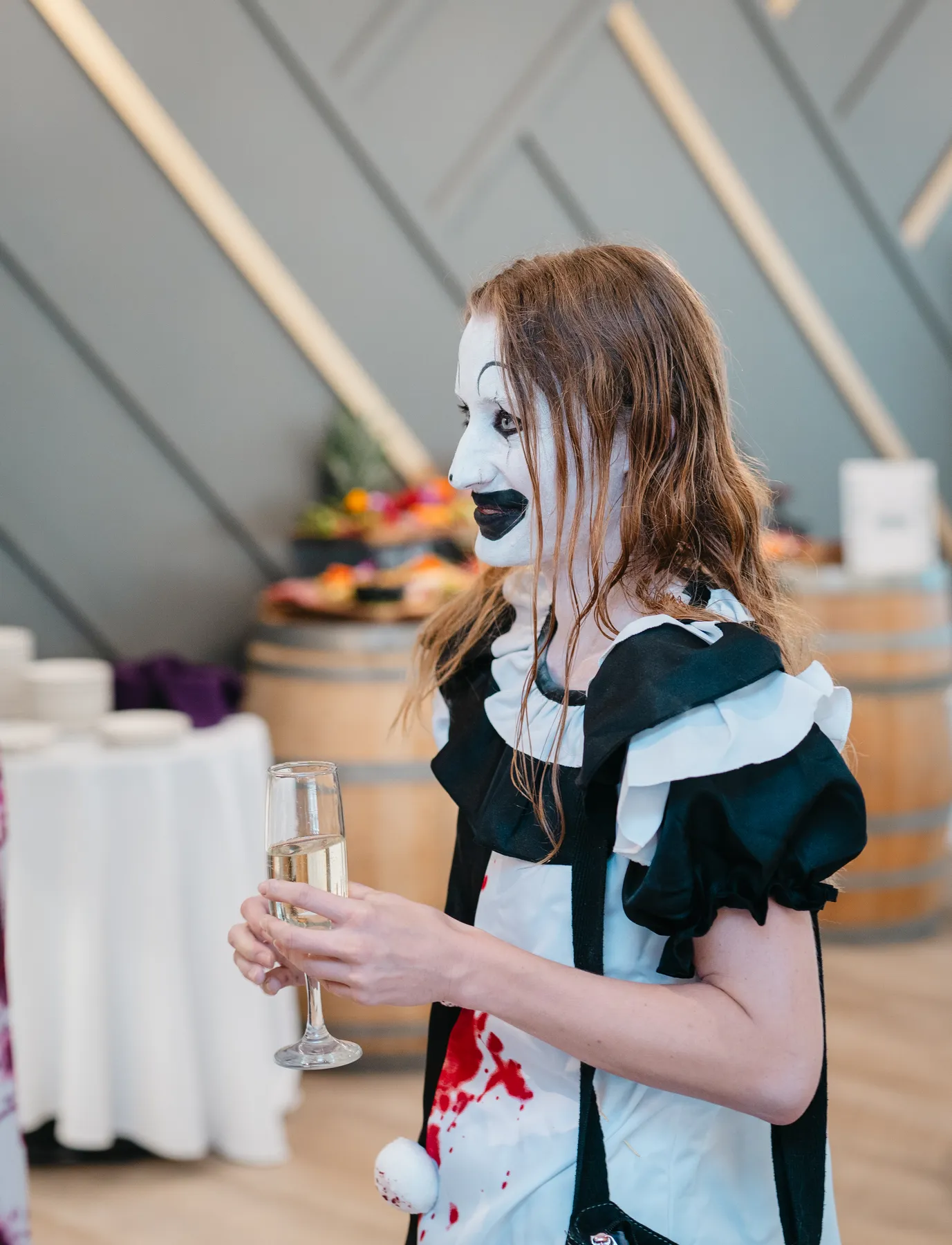 Costumed guests mingling indoors at Jenna and Jake’s Halloween party.