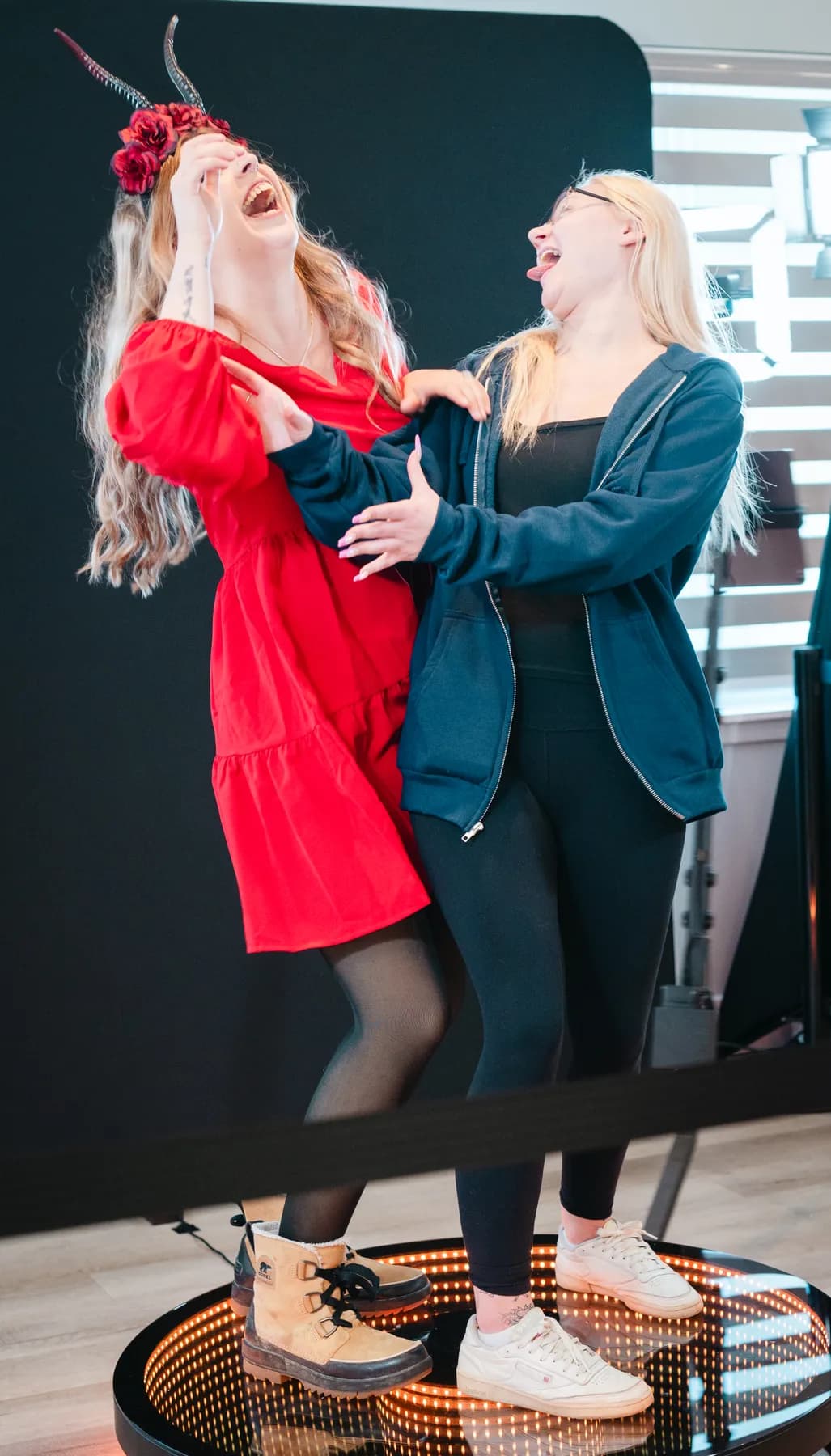 Two women dancing indoors at Jenna and Jake’s Halloween party.