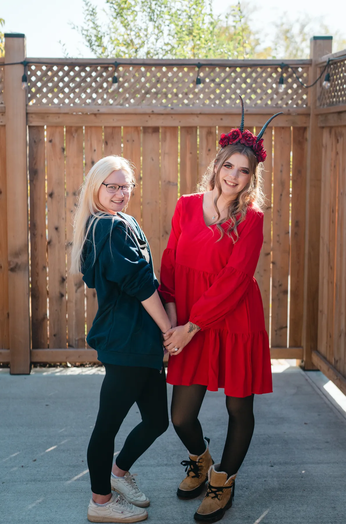Two women celebrating together in an outdoor courtyard at Jenna and Jake’s Halloween party.