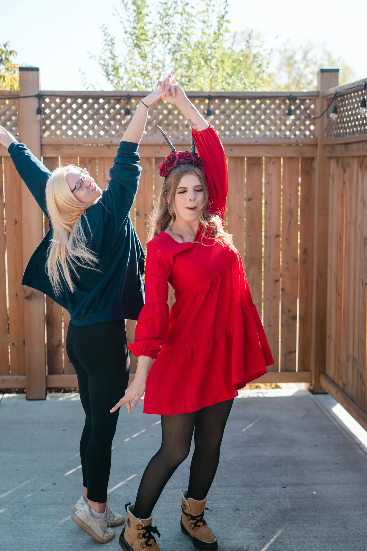 Two women celebrating together in an outdoor courtyard at Jenna and Jake’s Halloween party.