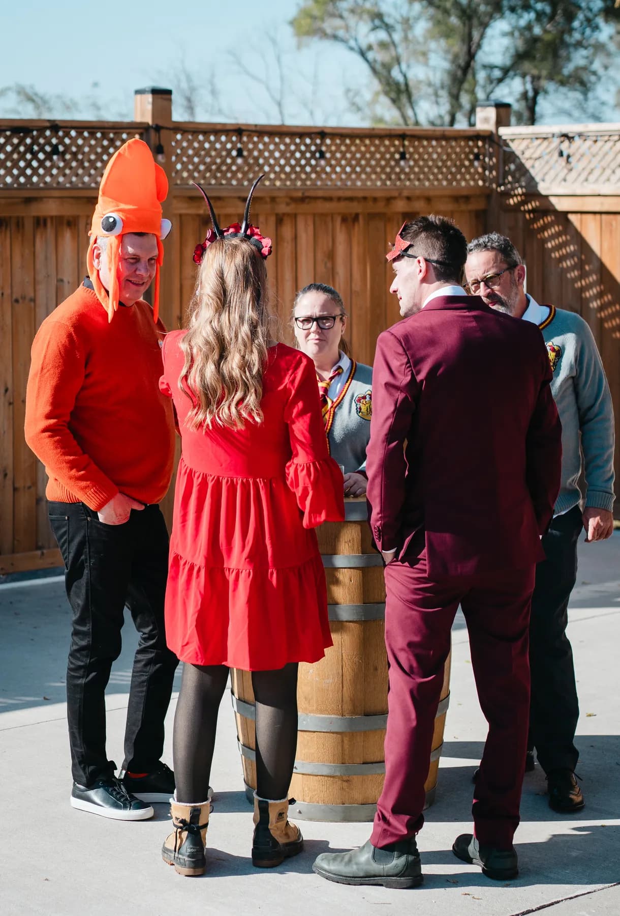 Costumed guests chatting in the outdoor courtyard at Jenna and Jake’s Halloween party.