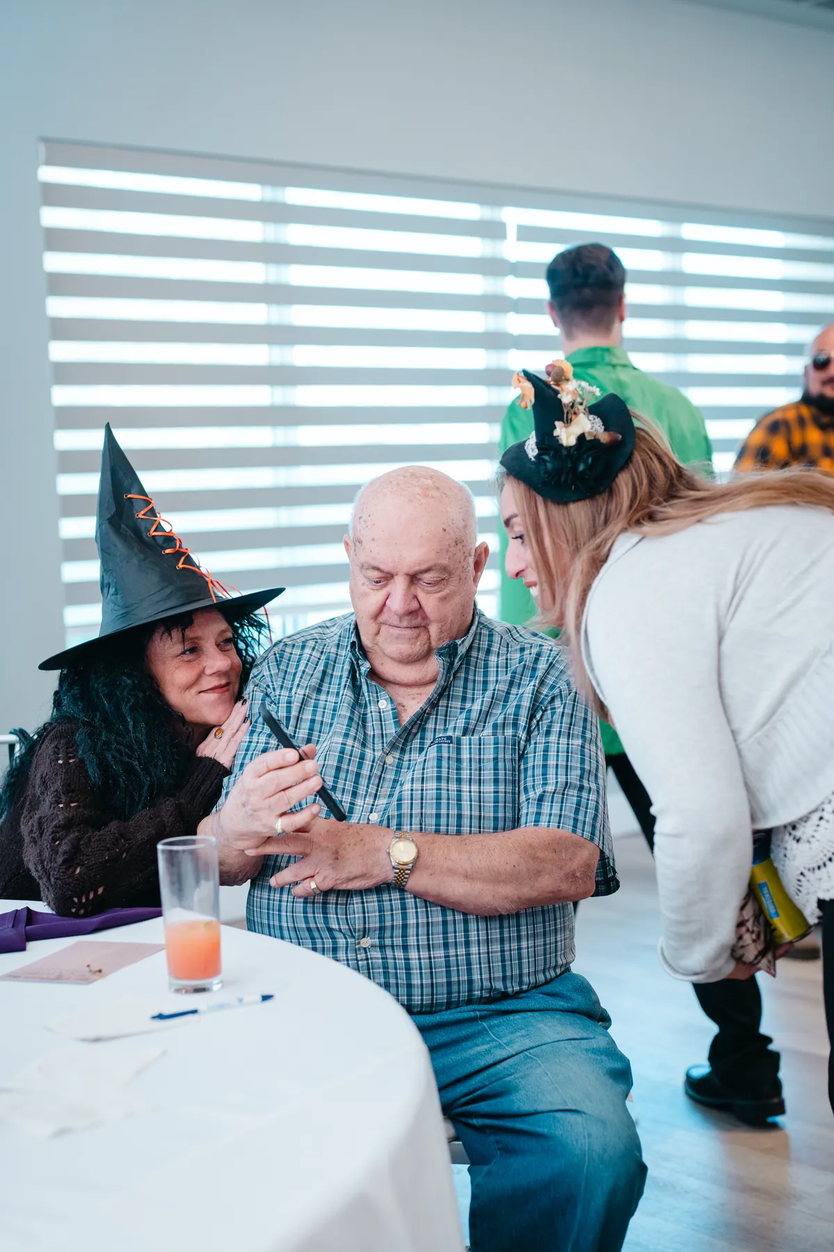 Guests in conversation at reception tables at Jenna and Jake’s Halloween party.