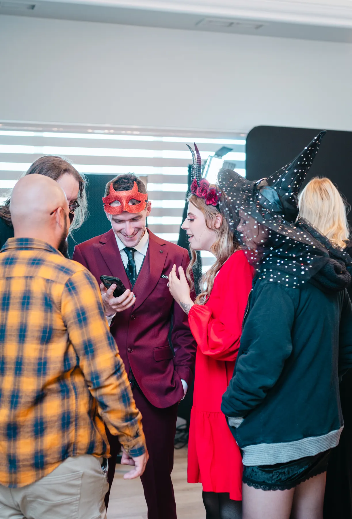 Guests in conversation at reception tables at Jenna and Jake’s Halloween party.