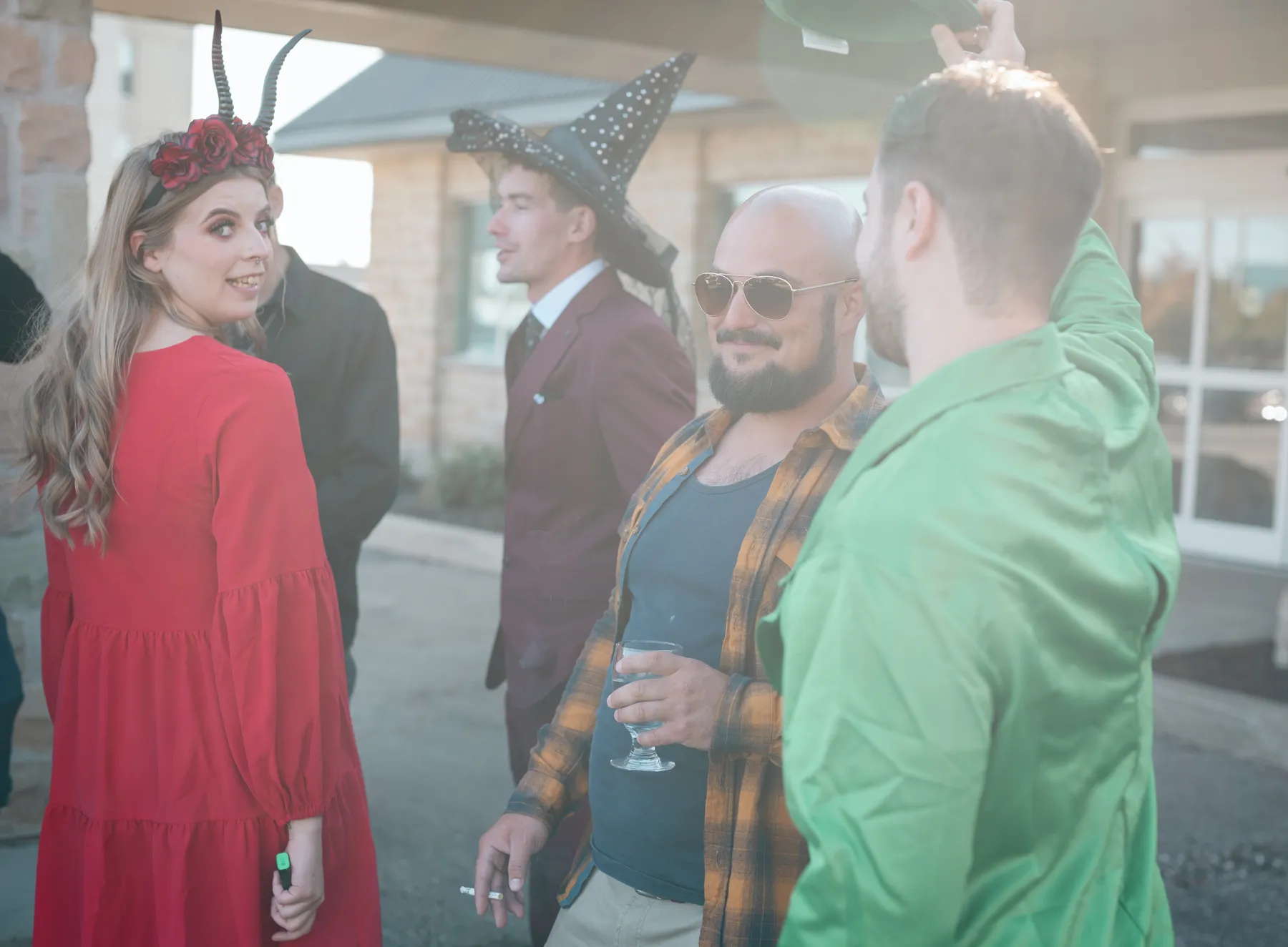 Costumed guests socializing at Jenna and Jake’s Halloween party.