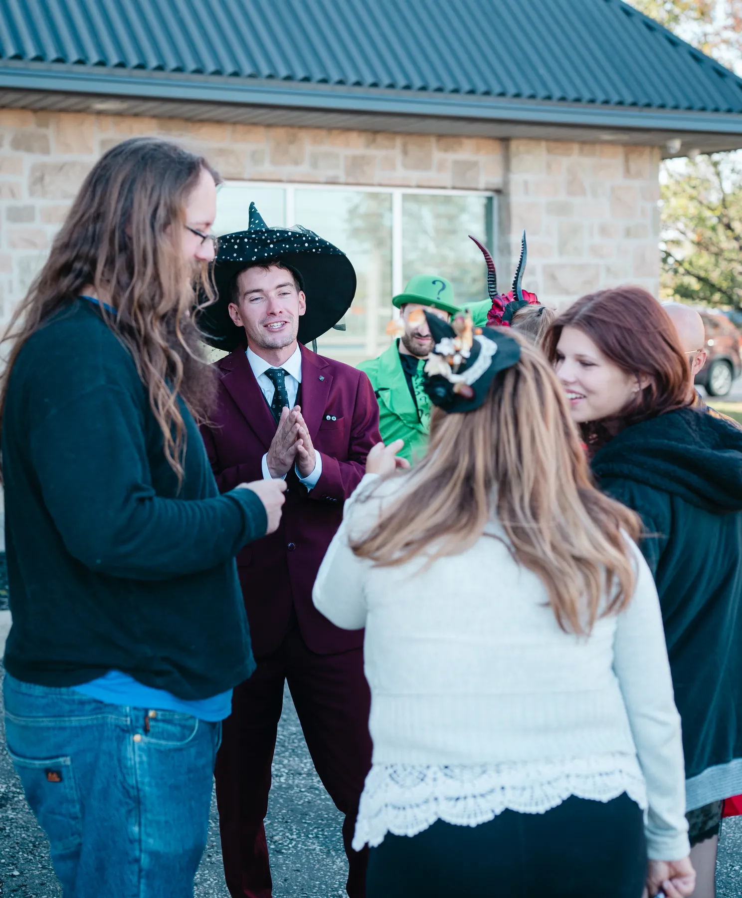 Costumed guests socializing at Jenna and Jake’s Halloween party.